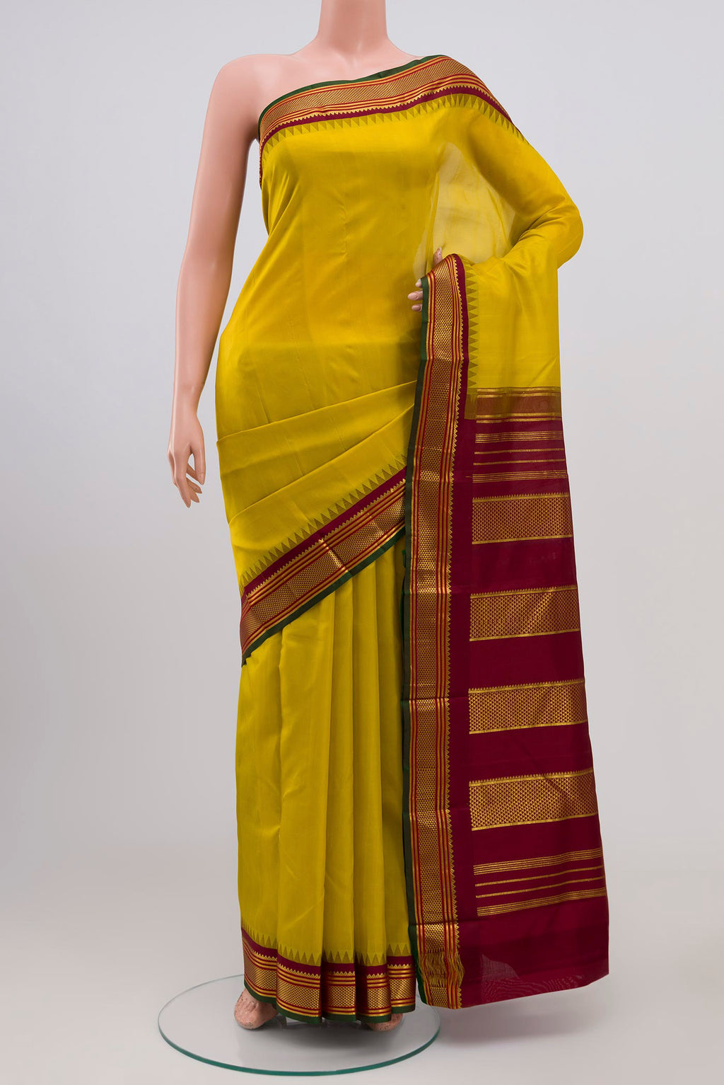 Lemon Yellow Kanjivaram Silk Saree with Plain Body and Zari Border.  displayed on a mannequin