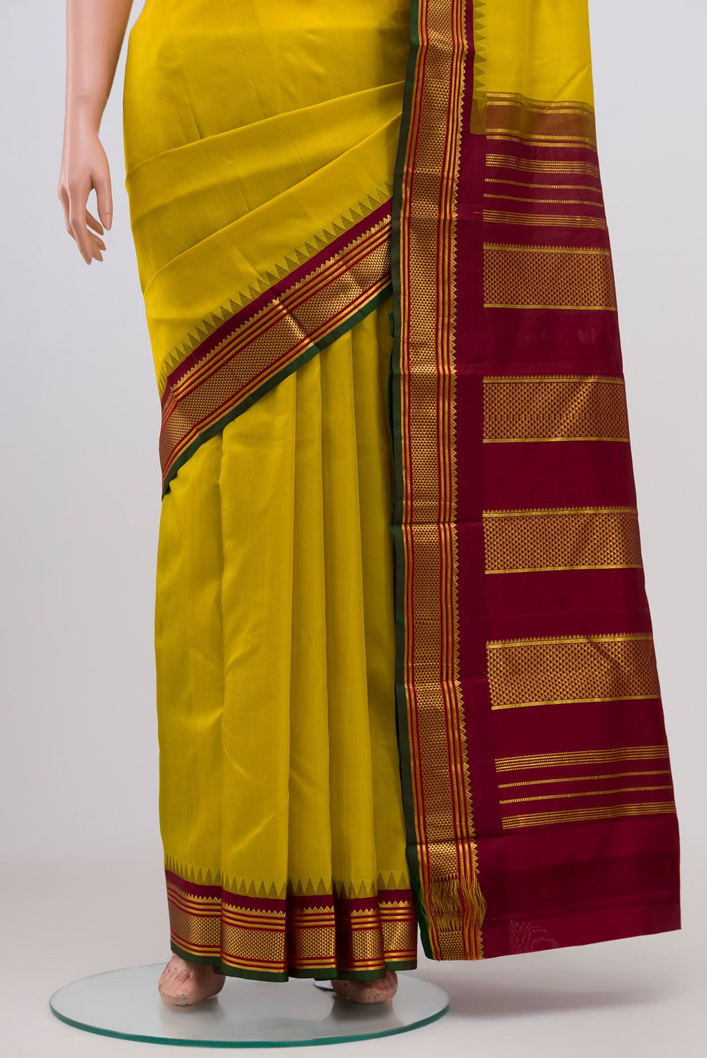 Pleats and pallu of Lemon Yellow Kanjivaram Silk Saree with Plain Body and Zari Border. 