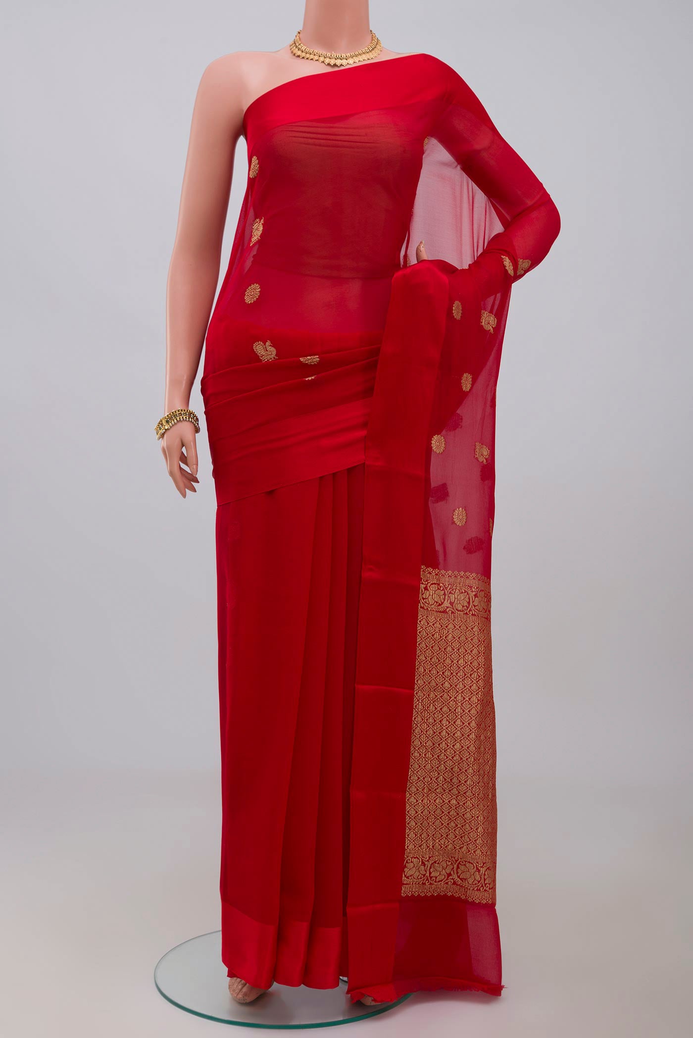 Red Chiffon Saree with Zari Butta on the body and Plain Border.  displayed on a mannequin