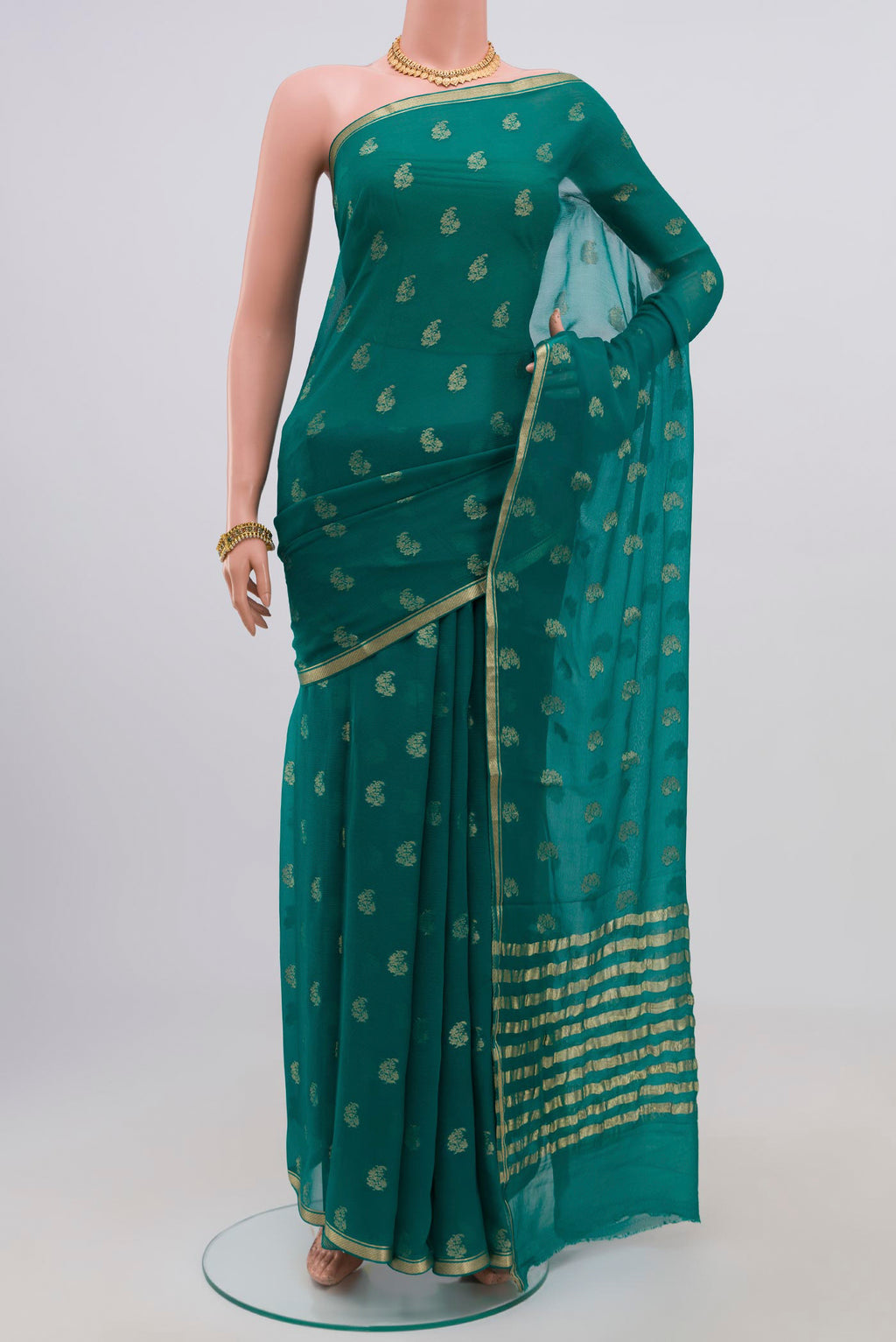 Green Chiffon Saree with Zari Butta on the body and Zari Border.  displayed on a mannequin