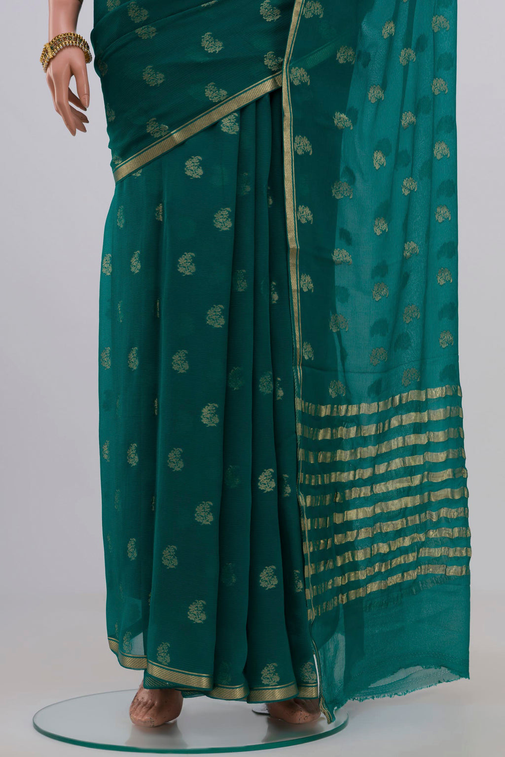 Pleats and pallu of Green Chiffon Saree with Zari Butta on the body and Zari Border. 