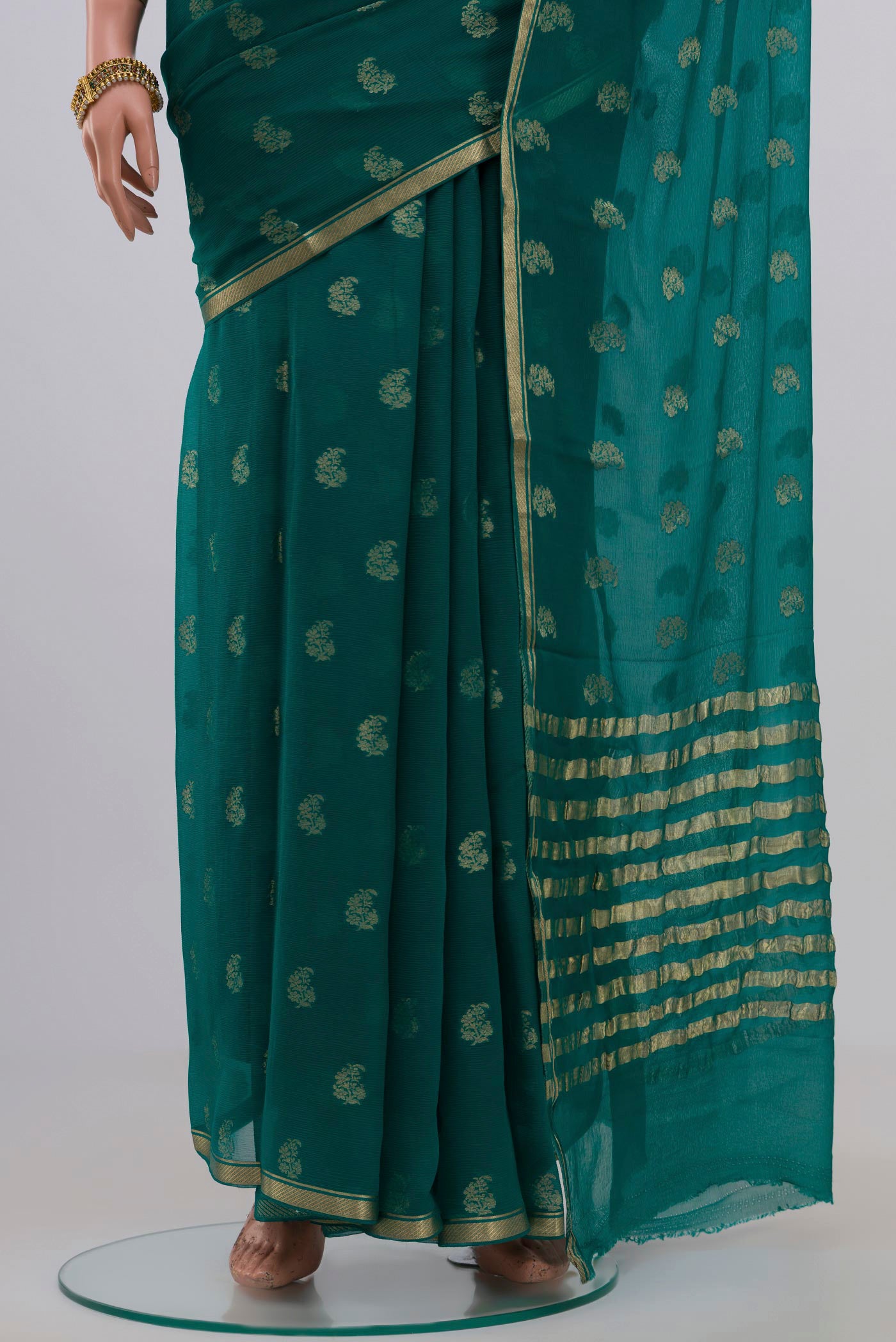 Pleats and pallu of Green Chiffon Saree with Zari Butta on the body and Zari Border. 