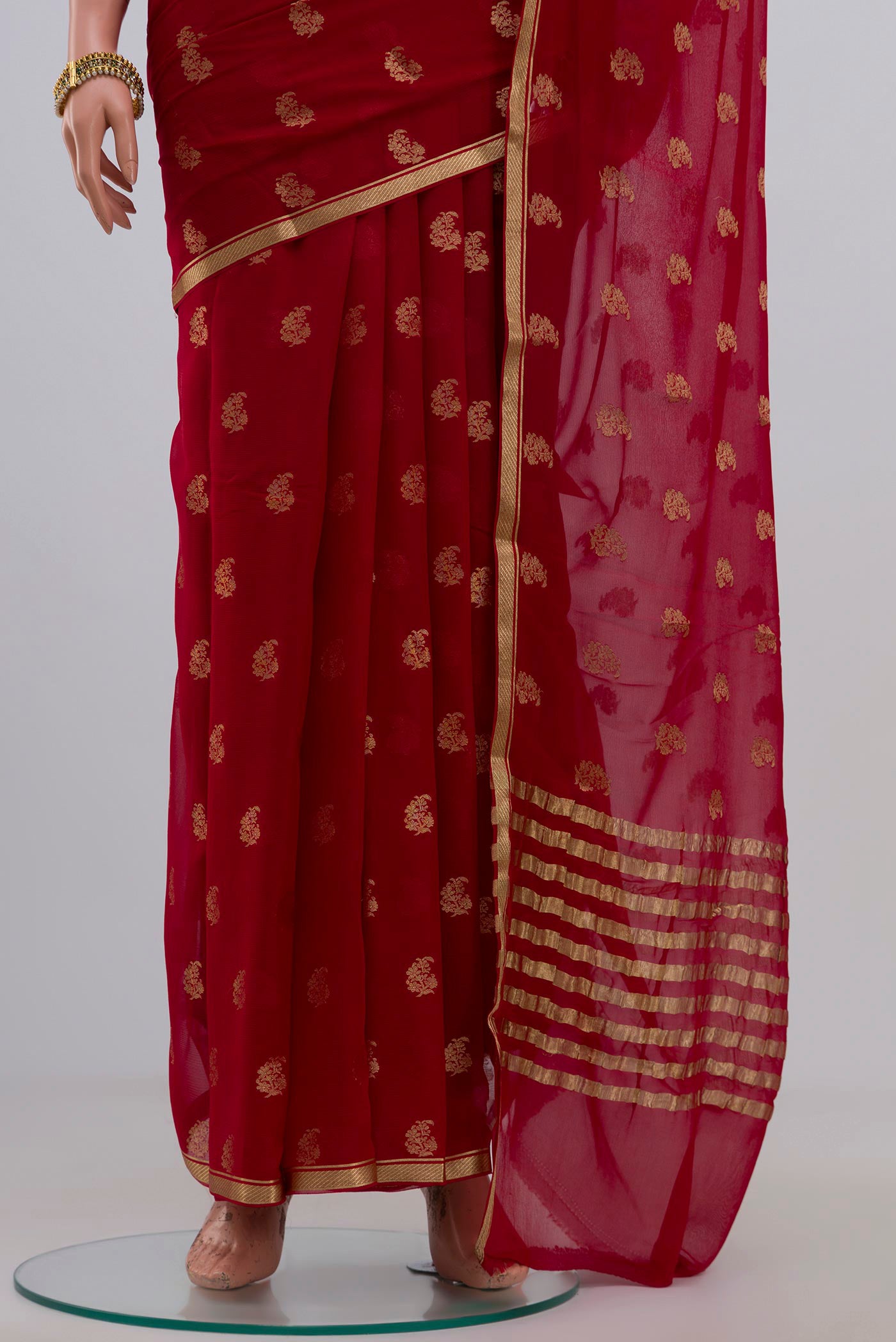 Pleats and pallu of Red Chiffon Saree with Zari Butta on the body and Zari Border. 