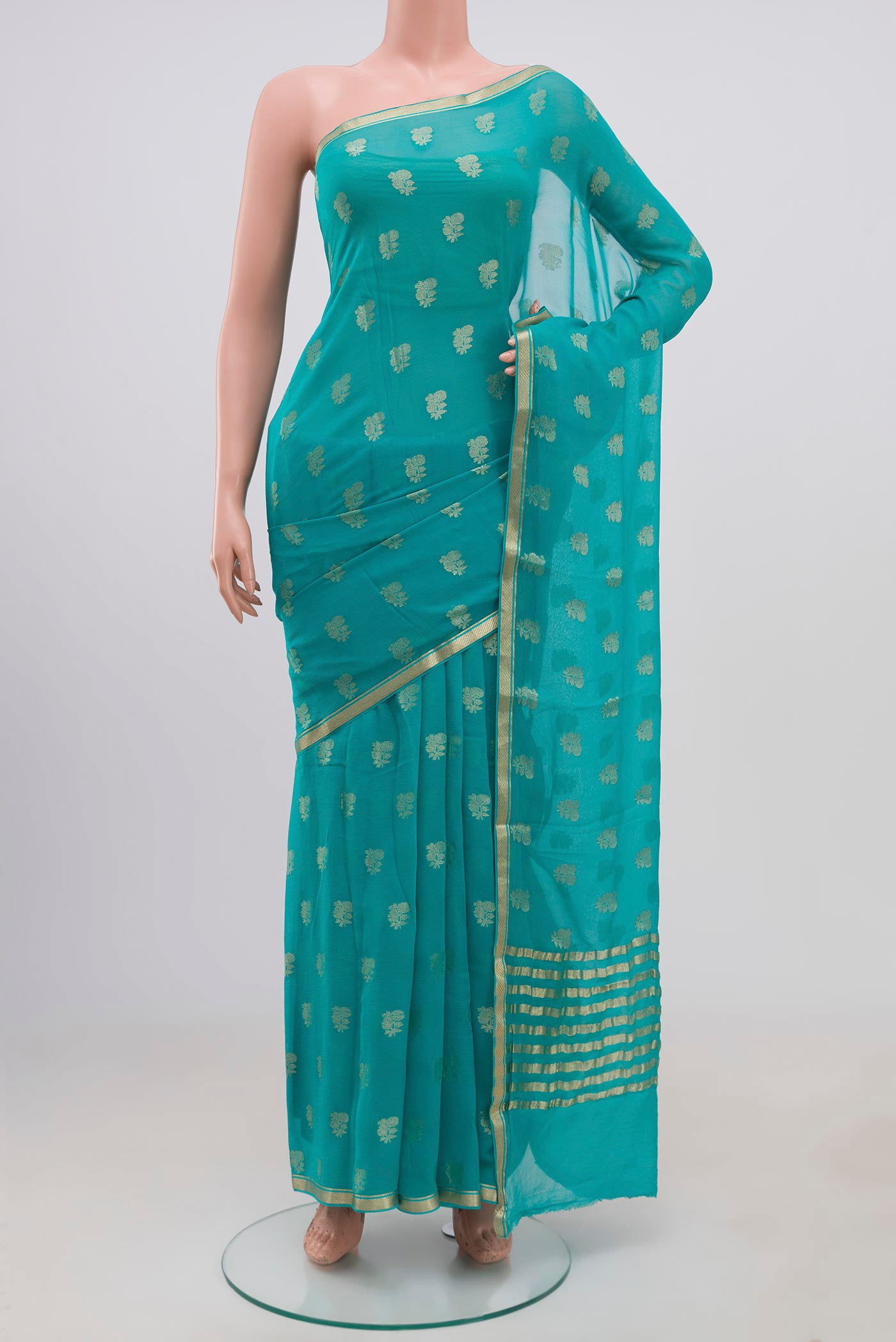Sky Blue Chiffon Saree with Zari Butta on the body and Zari Border.  displayed on a mannequin