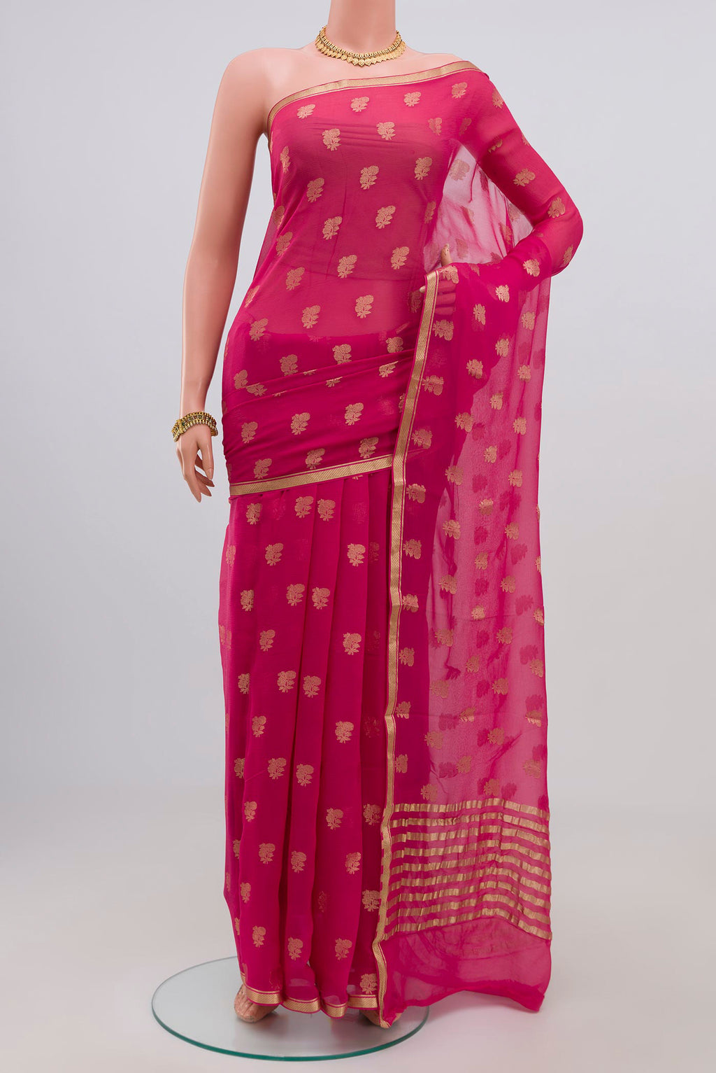 Pink Chiffon Saree with Zari Butta on the body and Zari Border.  displayed on a mannequin