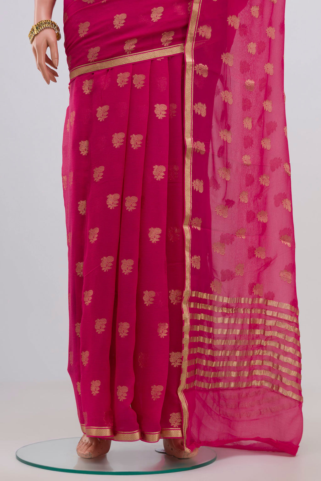 Pleats and pallu of Pink Chiffon Saree with Zari Butta on the body and Zari Border. 