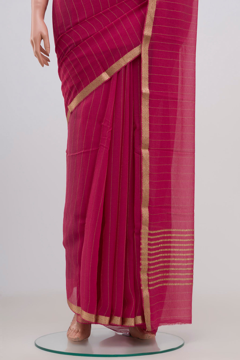 Pleats and pallu of Pink Chiffon Saree with Stripes on the body and Zari Border. 