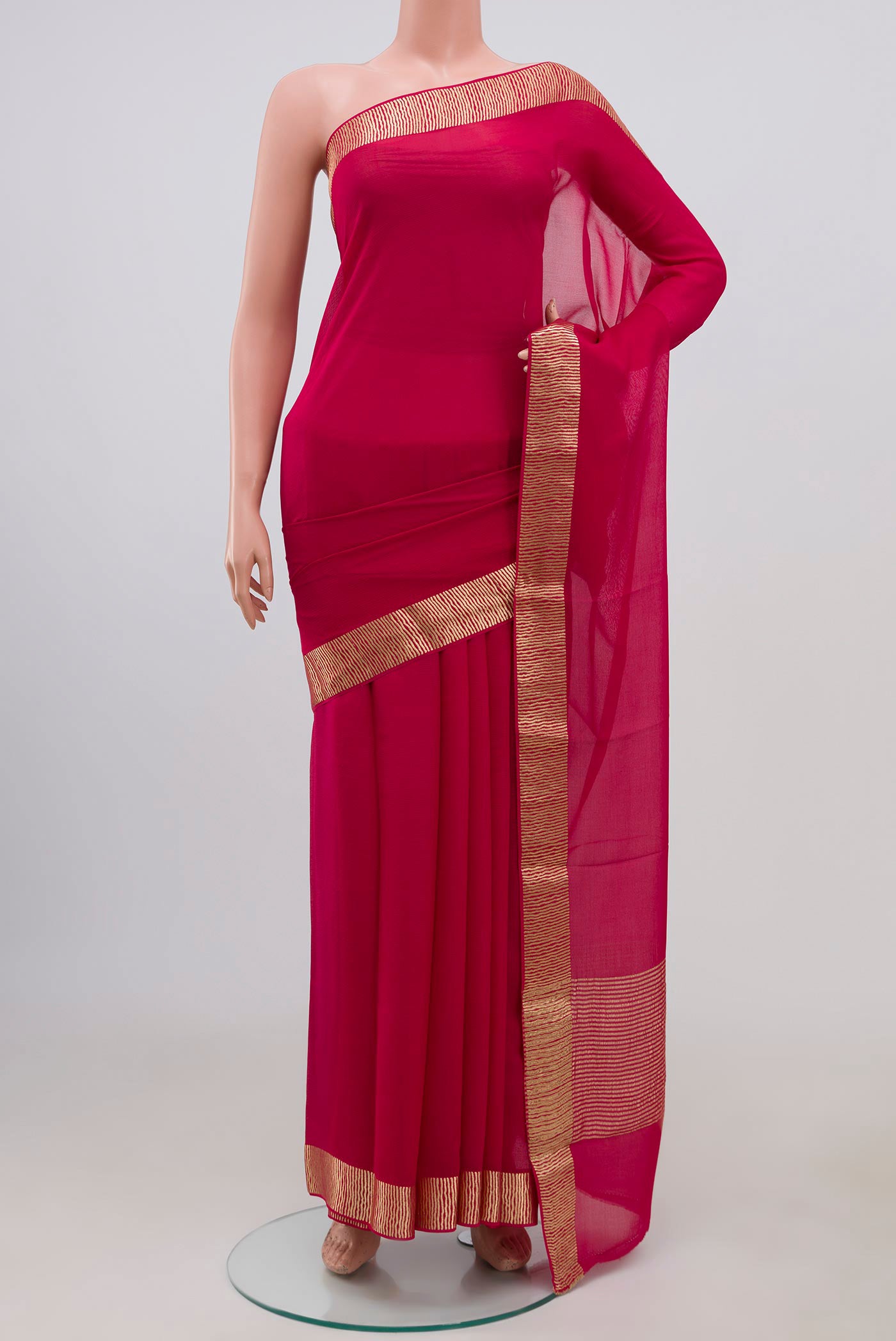 Pink Chiffon Saree with Plain Body and Zari Border.  displayed on a mannequin