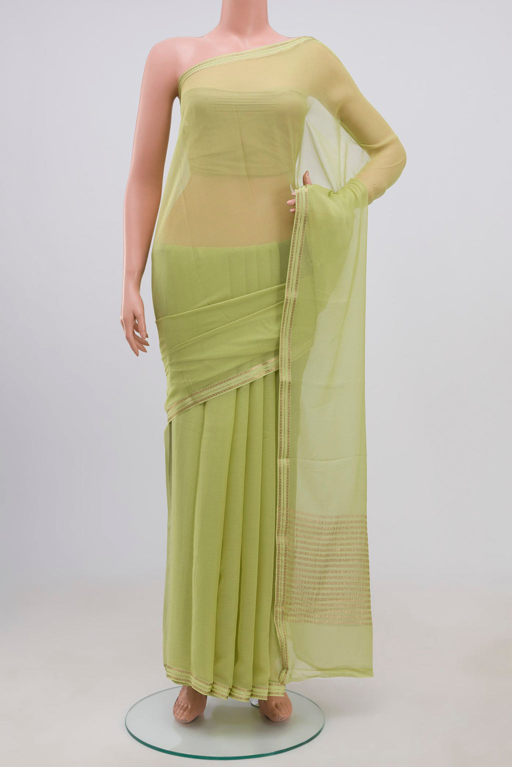 Pista Green Chiffon Saree with Plain Body and Zari Border.  displayed on a mannequin