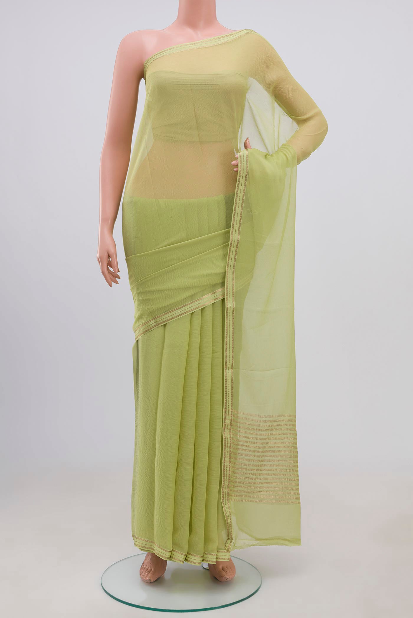 Pista Green Chiffon Saree with Plain Body and Zari Border.  displayed on a mannequin