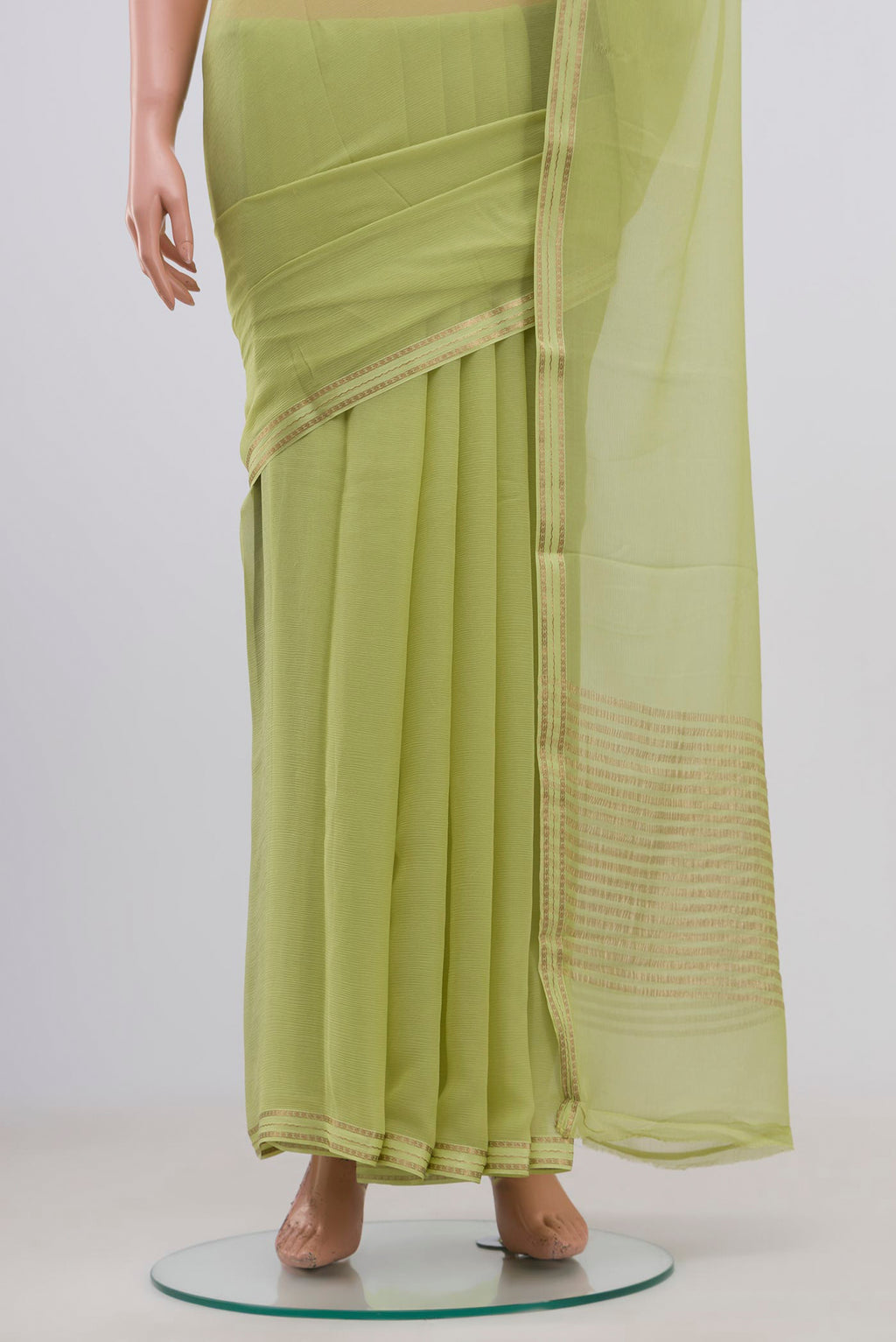 Pleats and pallu of Pista Green Chiffon Saree with Plain Body and Zari Border. 