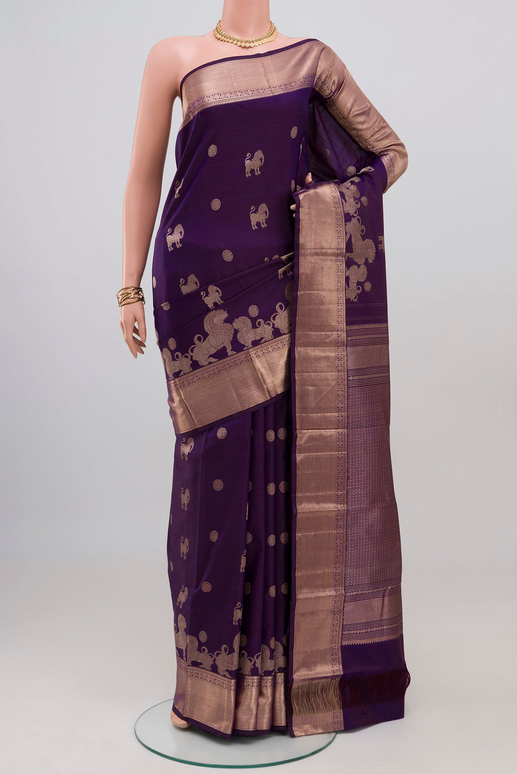Purple Kanchipuram Silk Saree with Zari Butta on the body and Zari Border.  displayed on a mannequin