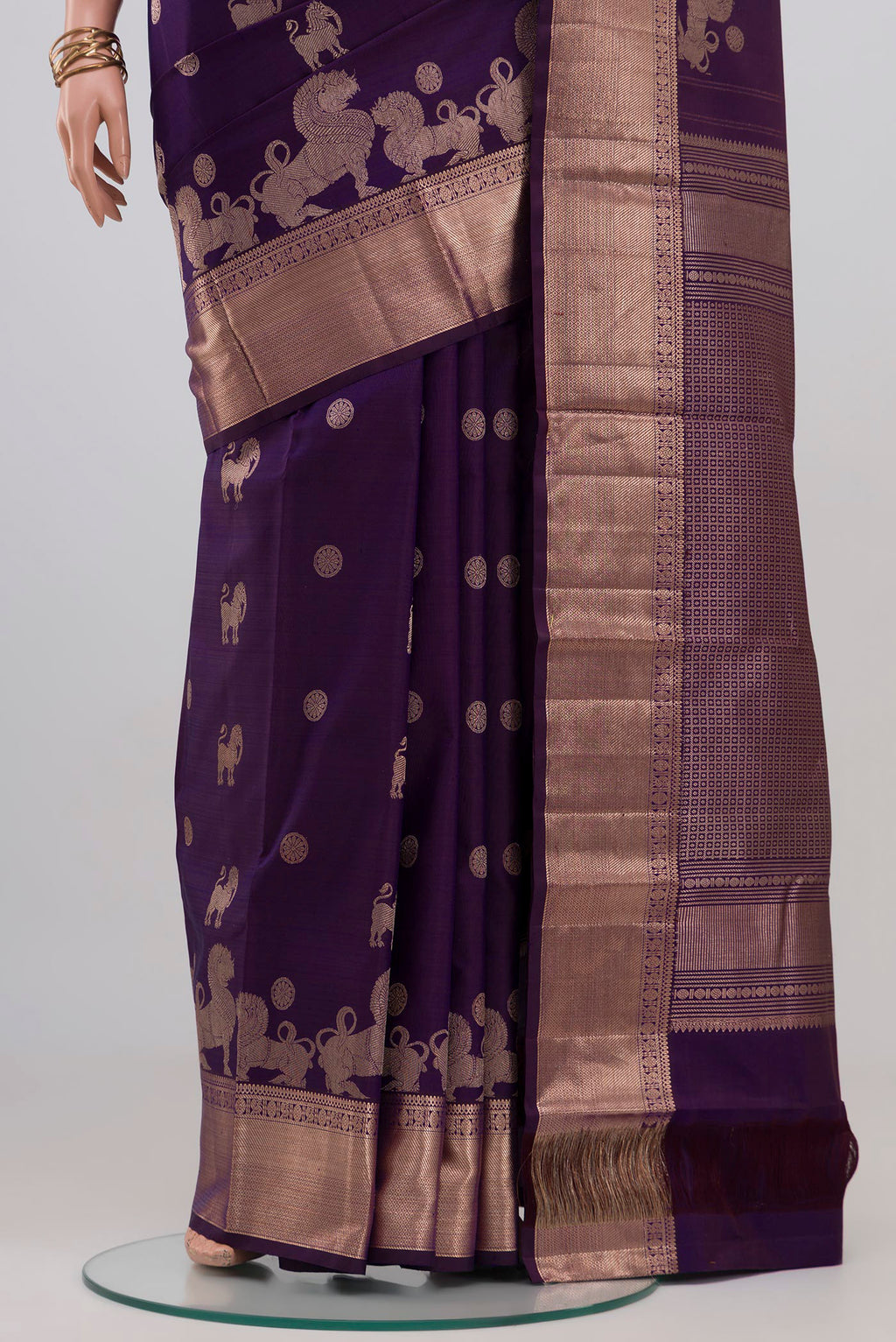 Pleats and pallu of Purple Kanchipuram Silk Saree with Zari Butta on the body and Zari Border. 