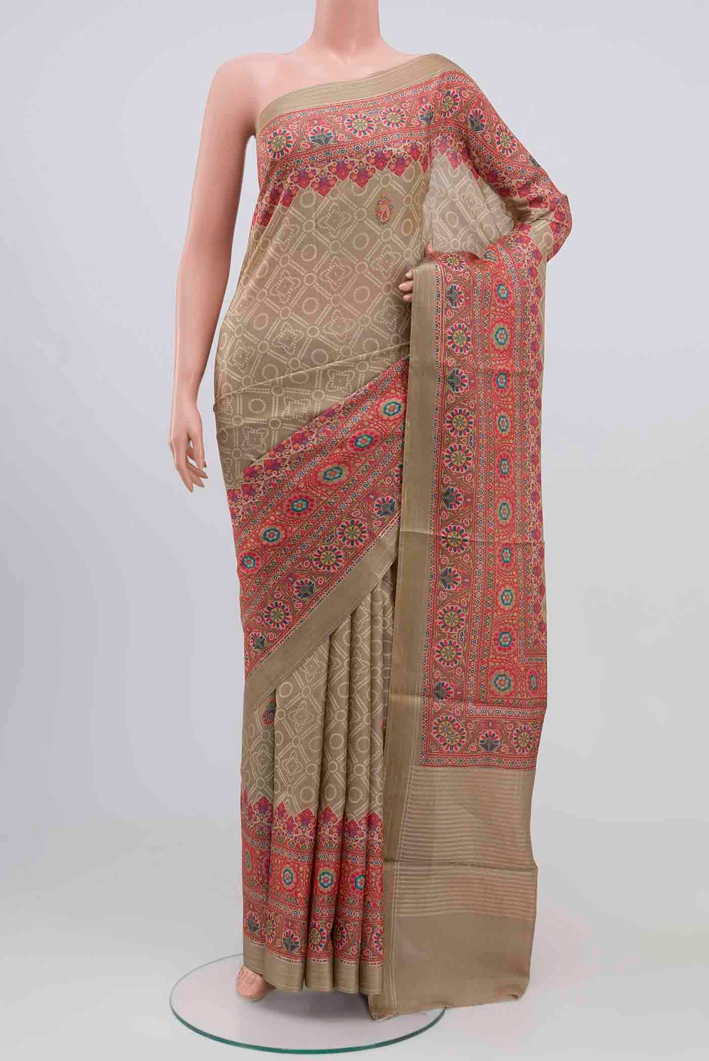 Beige Tussar Silk Saree with Printed design on the body and Zari Border.  displayed on a mannequin