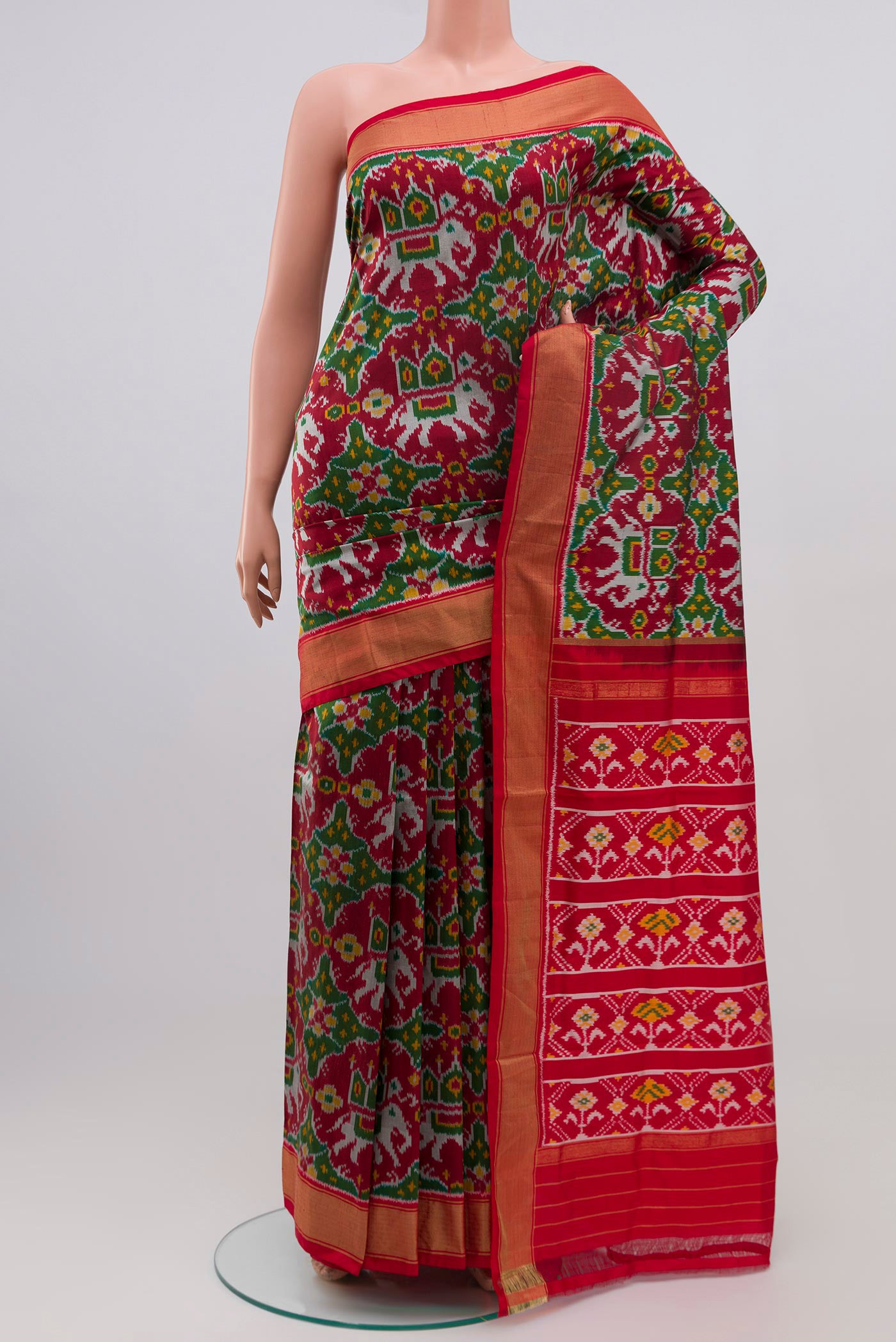 Maroon Pochampally Silk Saree with Ikat Print on the body and Zari Border.  displayed on a mannequin