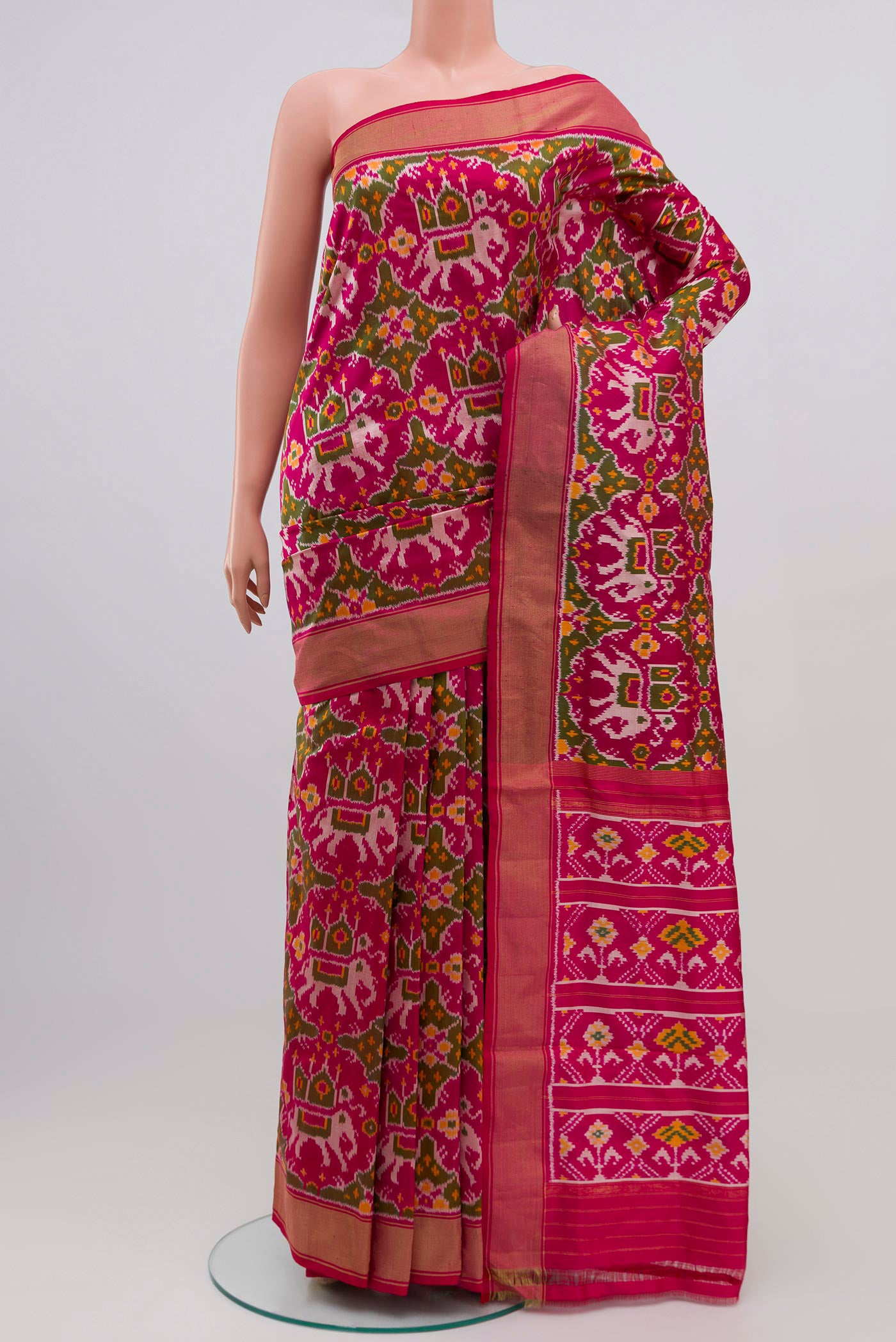 Pink Pochampally Silk Saree with Ikat Print on the body and Zari Border.  displayed on a mannequin