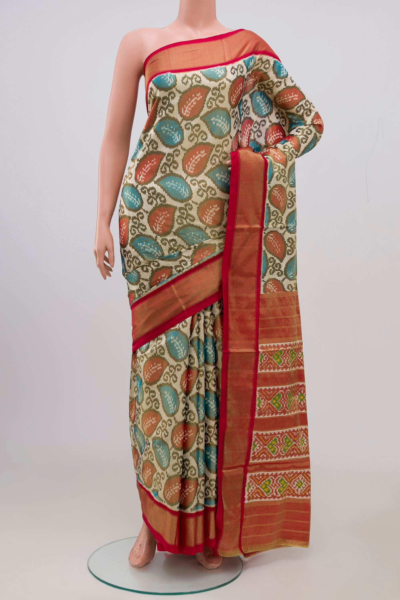 Off White Pochampally Silk Saree with Ikat Print on the body and Zari Border.  displayed on a mannequin