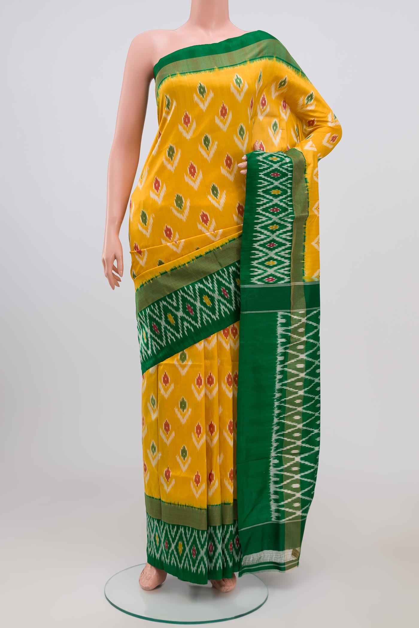 Yellow Pochampally Silk Saree with Ikat Print on the body and Ikat Border.  displayed on a mannequin