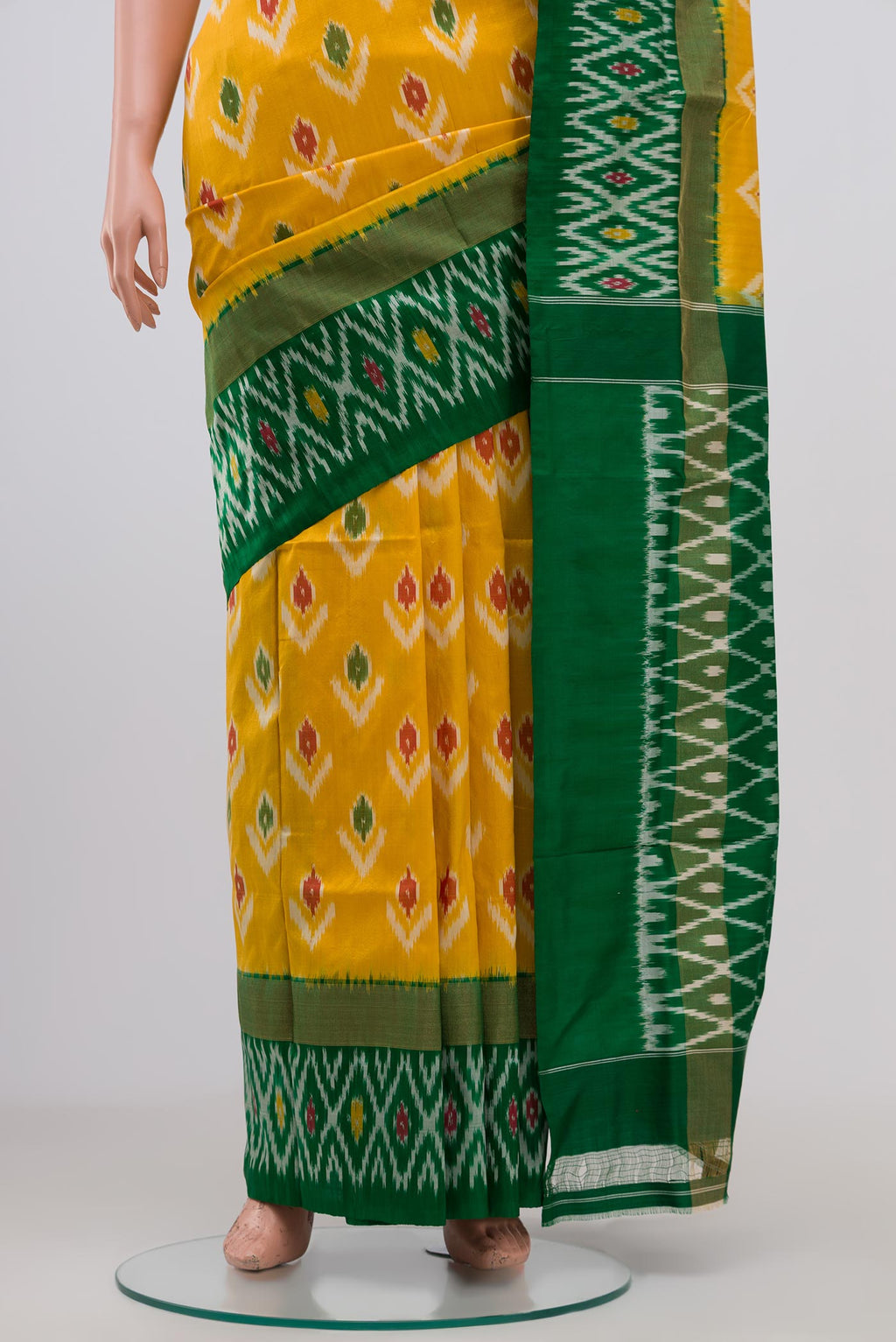 Pleats and pallu of Yellow Pochampally Silk Saree with Ikat Print on the body and Ikat Border. 