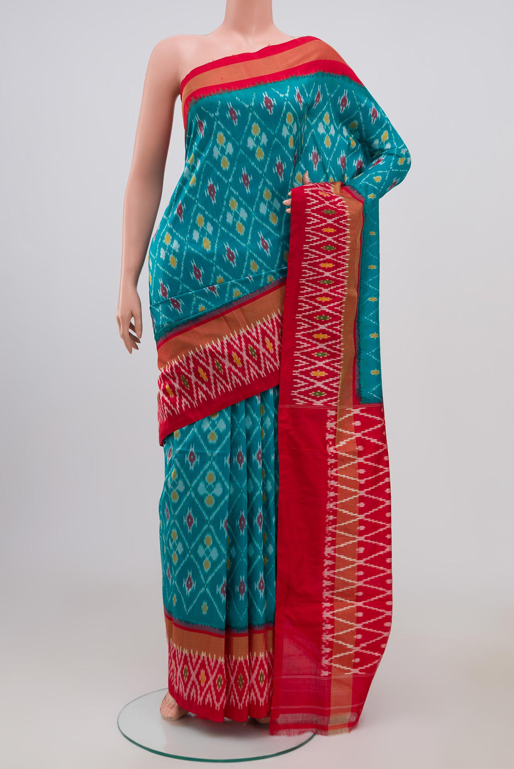 Sky Blue Pochampally Silk Saree with Ikat Print on the body and Ikat Border.  displayed on a mannequin