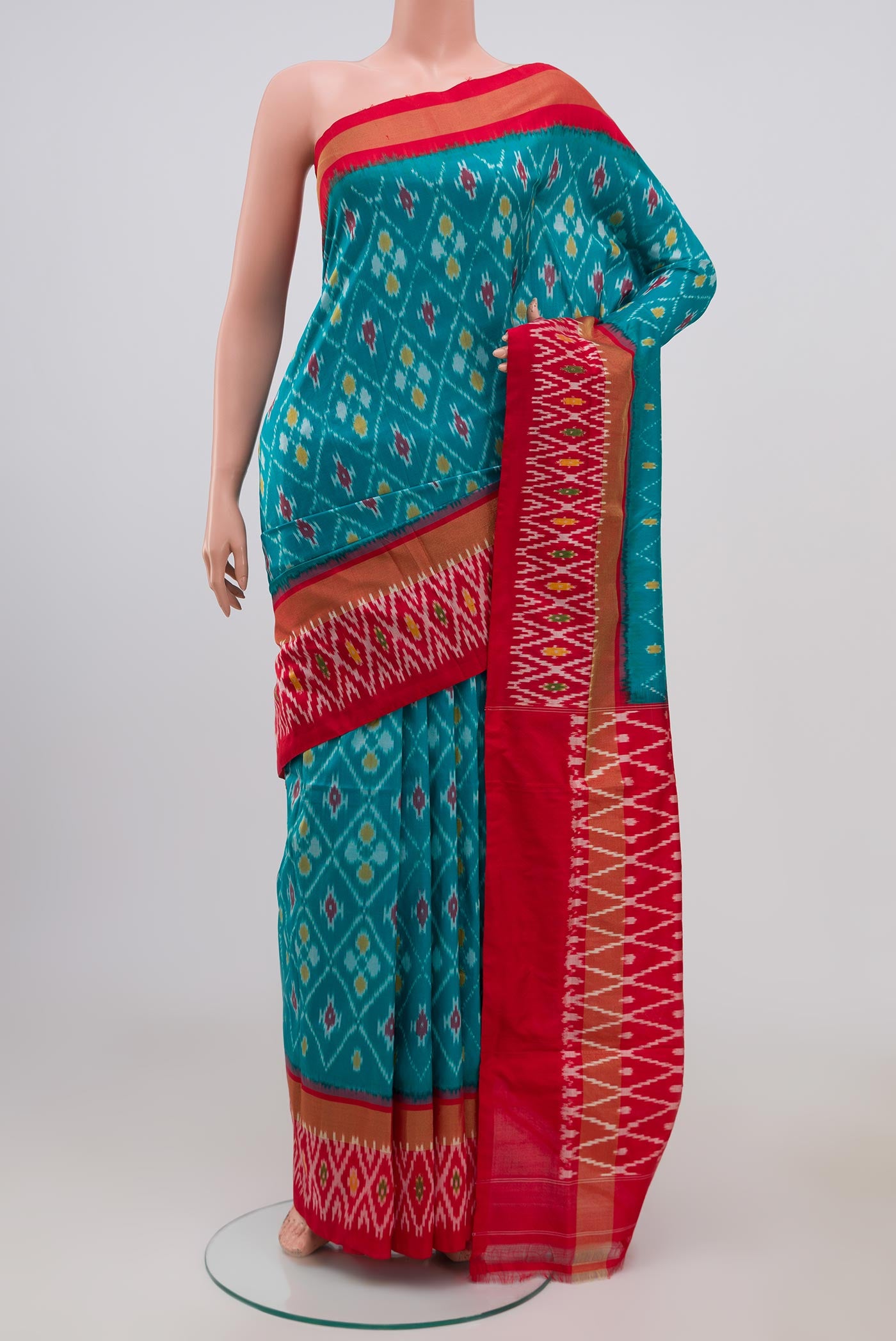Sky Blue Pochampally Silk Saree with Ikat Print on the body and Ikat Border.  displayed on a mannequin