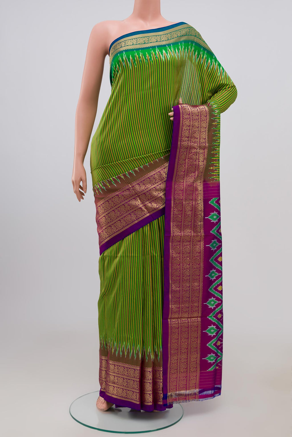 Green Pochampally Silk Saree with Stripes on the body and Zari Border.  displayed on a mannequin