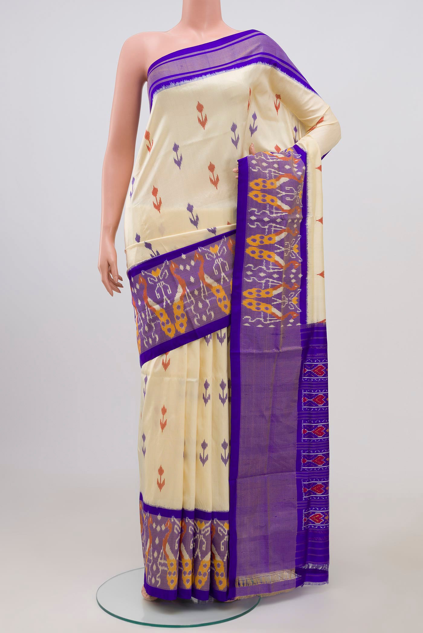 Cream Pochampally Silk Saree with Ikat Print on the body and Ikat Border.  displayed on a mannequin