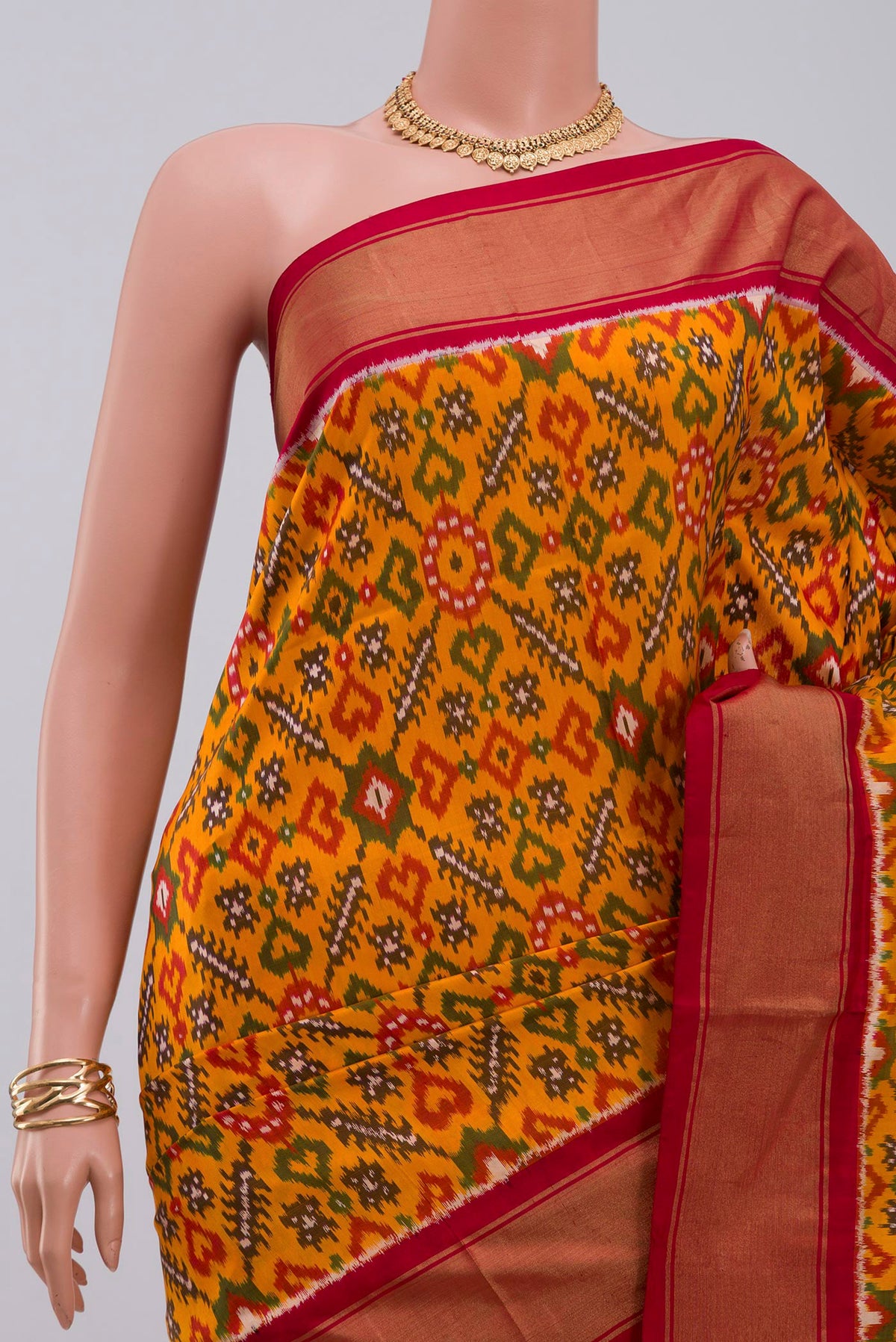 Border image of Yellow Pochampally Silk Saree with Ikat design on the body and Zari Border. 