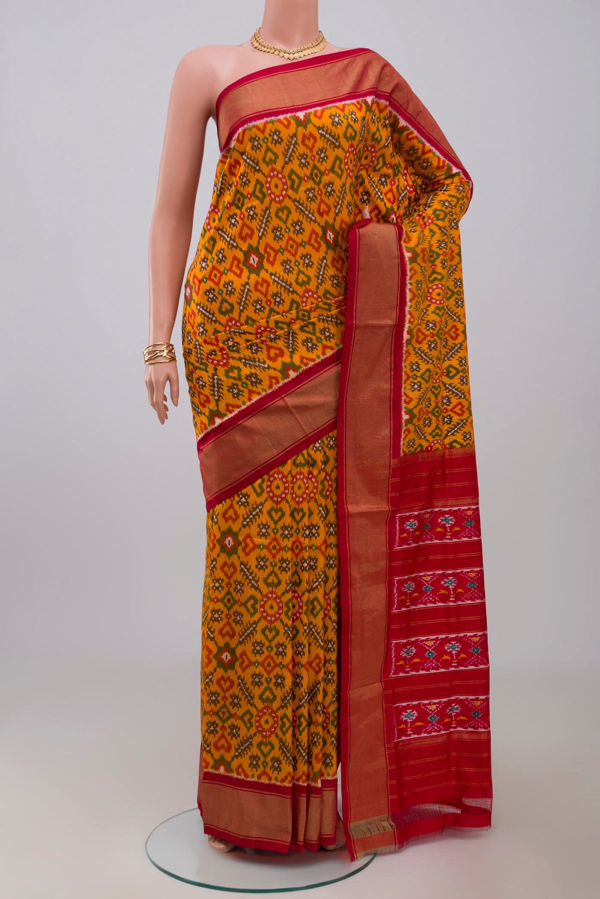 Yellow Pochampally Silk Saree with Ikat design on the body and Zari Border.  displayed on a mannequin