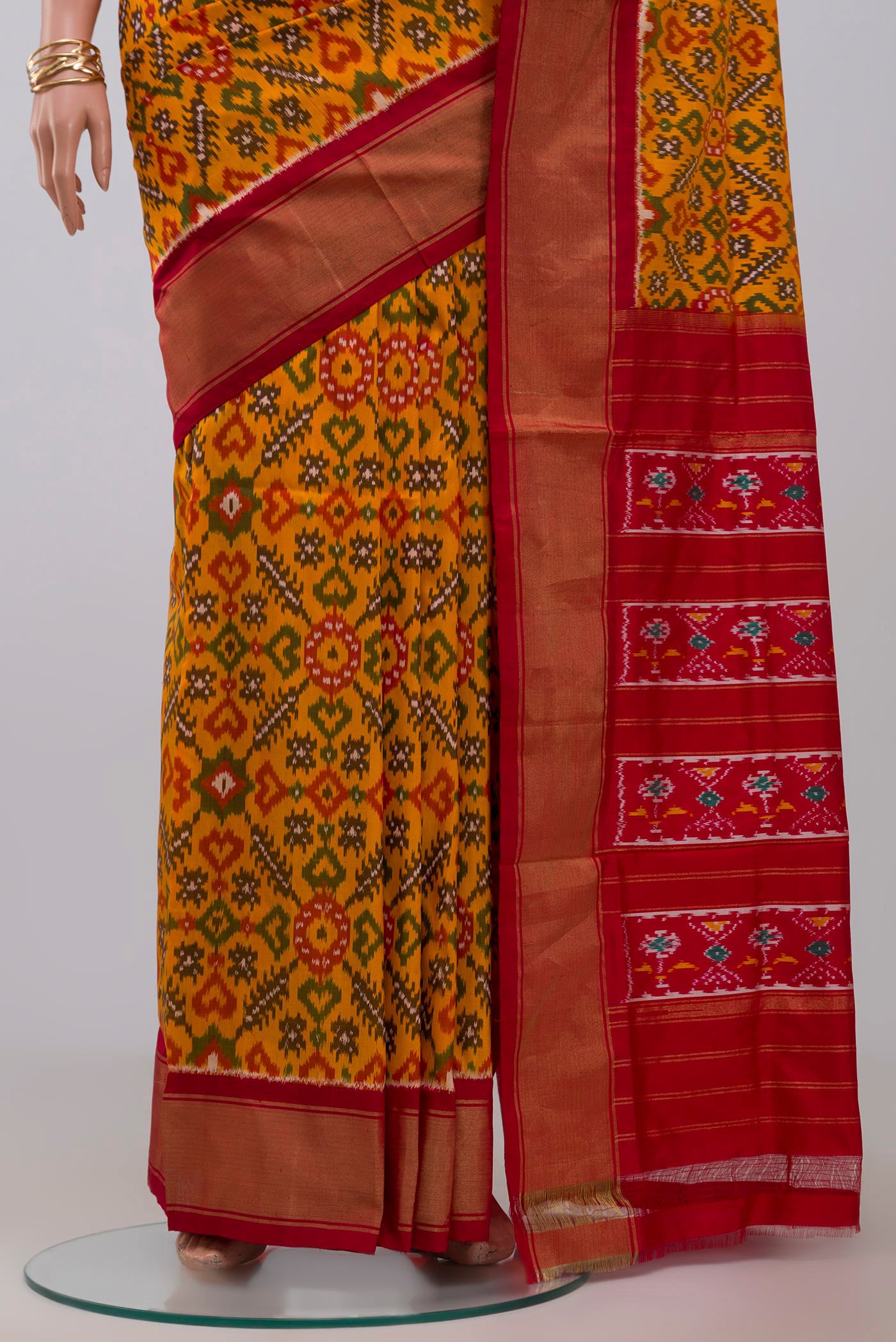 Pleats and pallu of Yellow Pochampally Silk Saree with Ikat design on the body and Zari Border. 