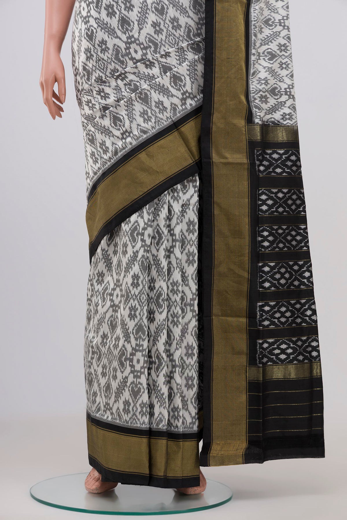 Pleats and pallu of White Pochampally Silk Saree with Ikat Print on the body and Zari Border. 