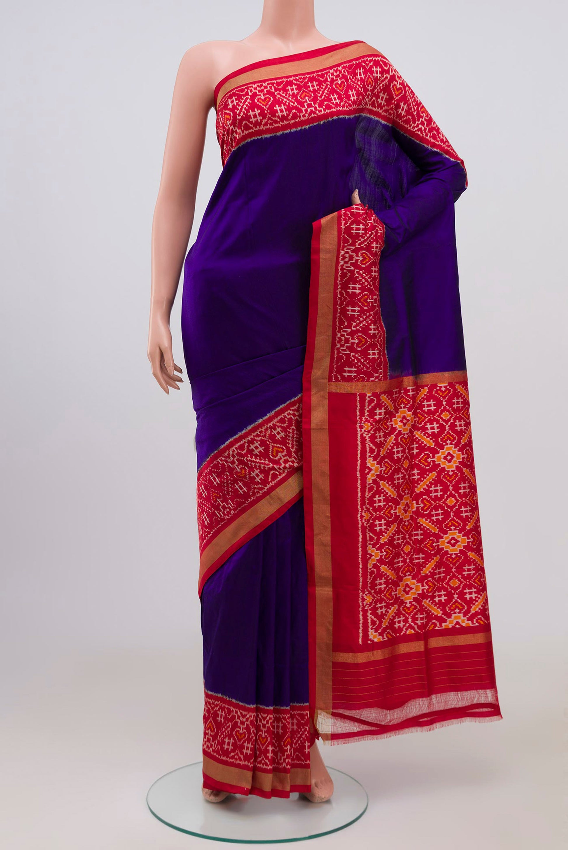 Blue Pochampally Silk Saree with Plain Body and Ikat Border.  displayed on a mannequin