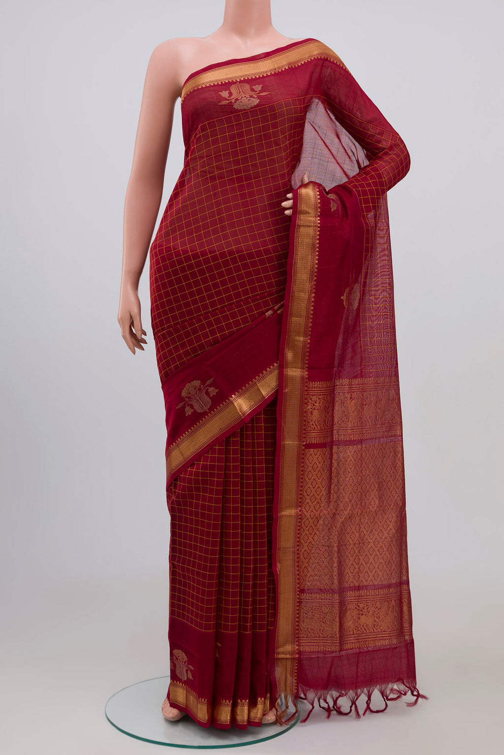 Maroon Silk Cotton Saree with Checked design on the body and Zari Border.  displayed on a mannequin