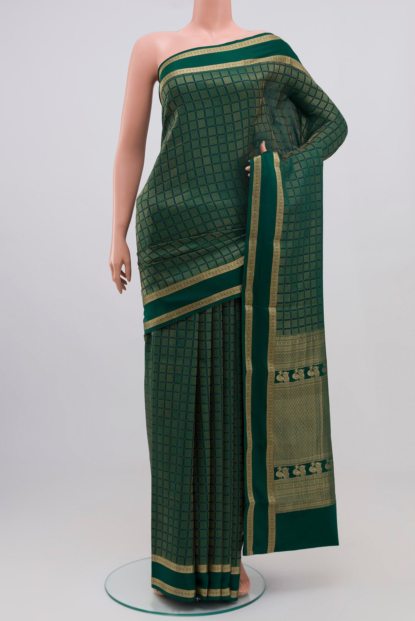 Green Crepe Saree with Zari Brocade on the body and Zari Border.  displayed on a mannequin