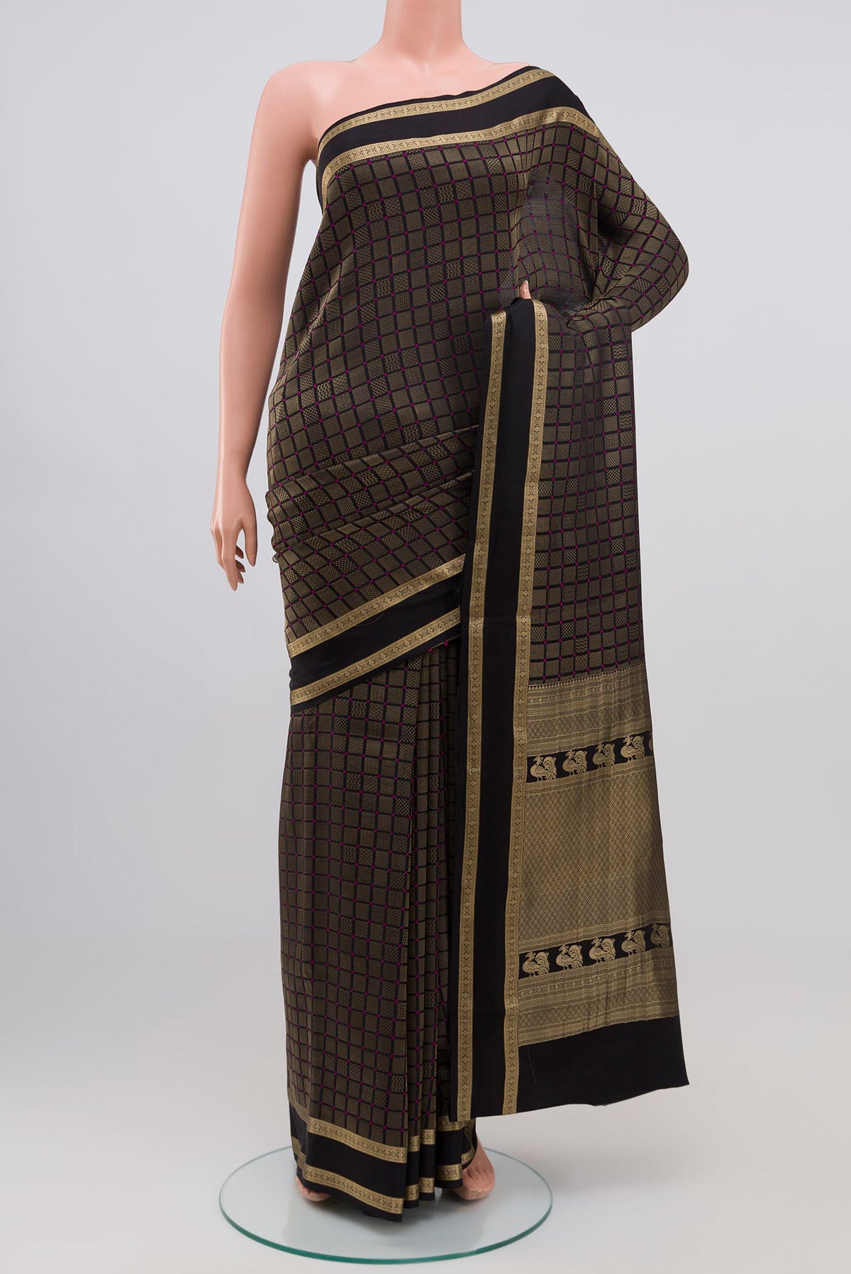 Black Crepe Saree with Zari Brocade on the body and Zari Border.  displayed on a mannequin