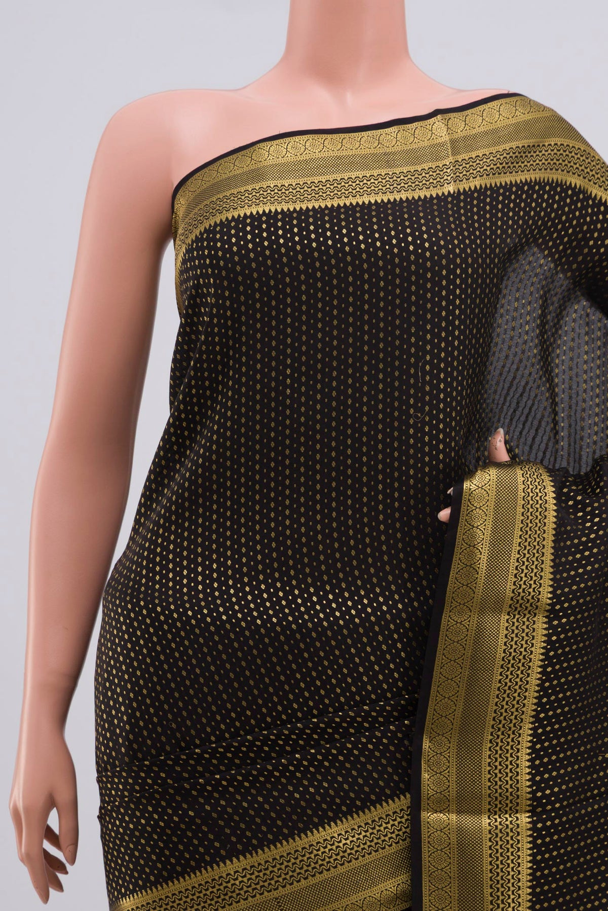Border image of Black Crepe Saree with Zari Butta on the body and Zari Border. 
