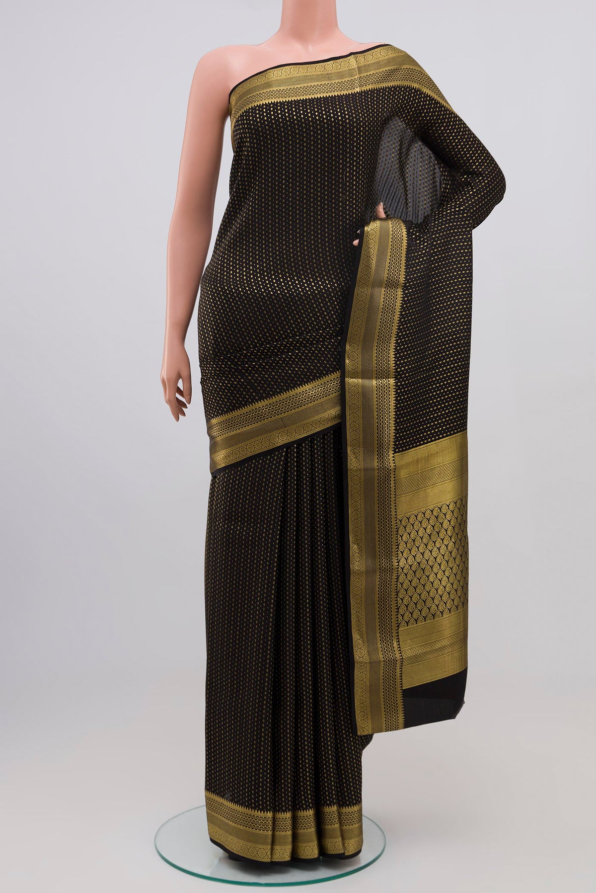 Black Crepe Saree with Zari Butta on the body and Zari Border.  displayed on a mannequin