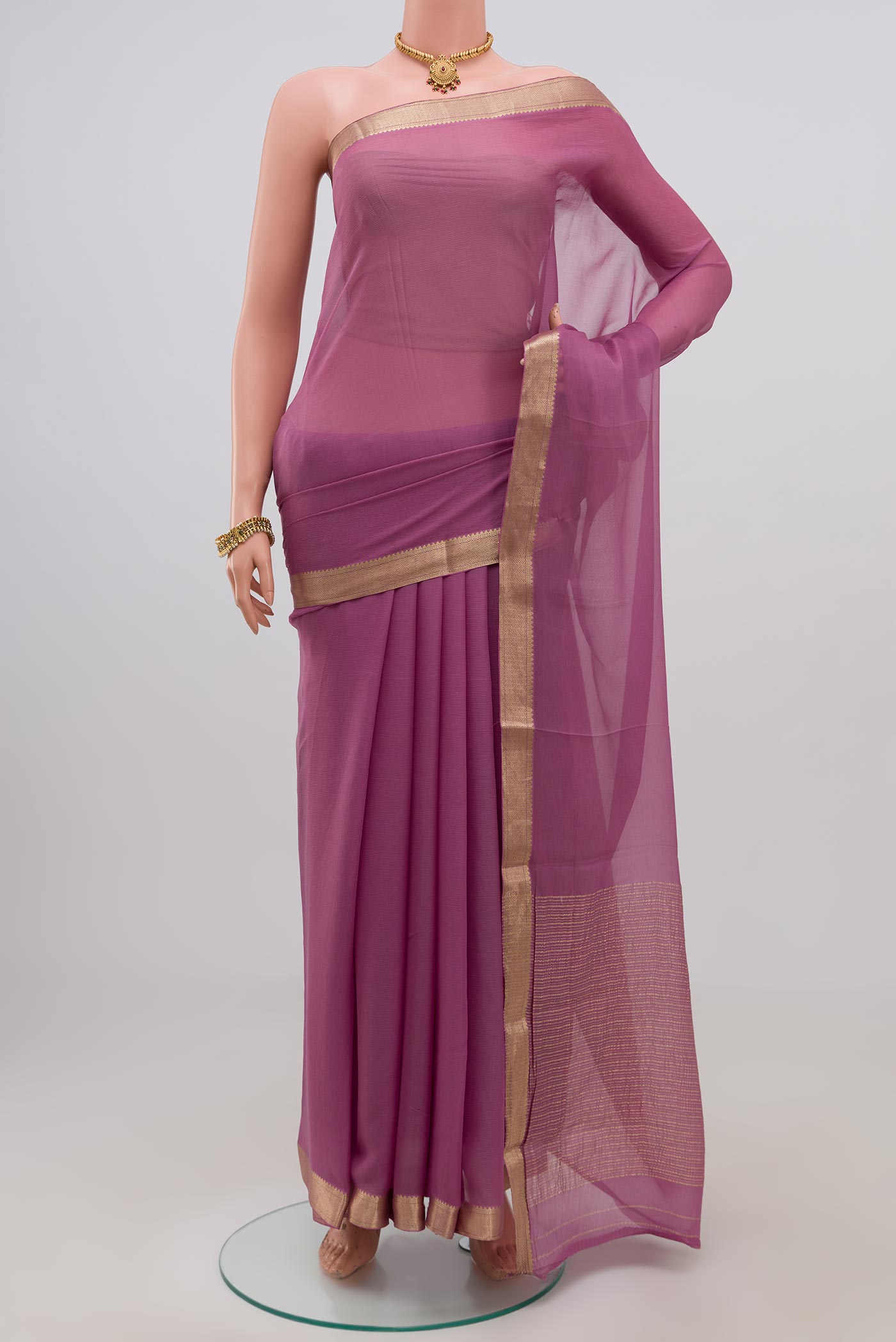 Lavender Chiffon Saree with Plain Body and Zari Border.  displayed on a mannequin