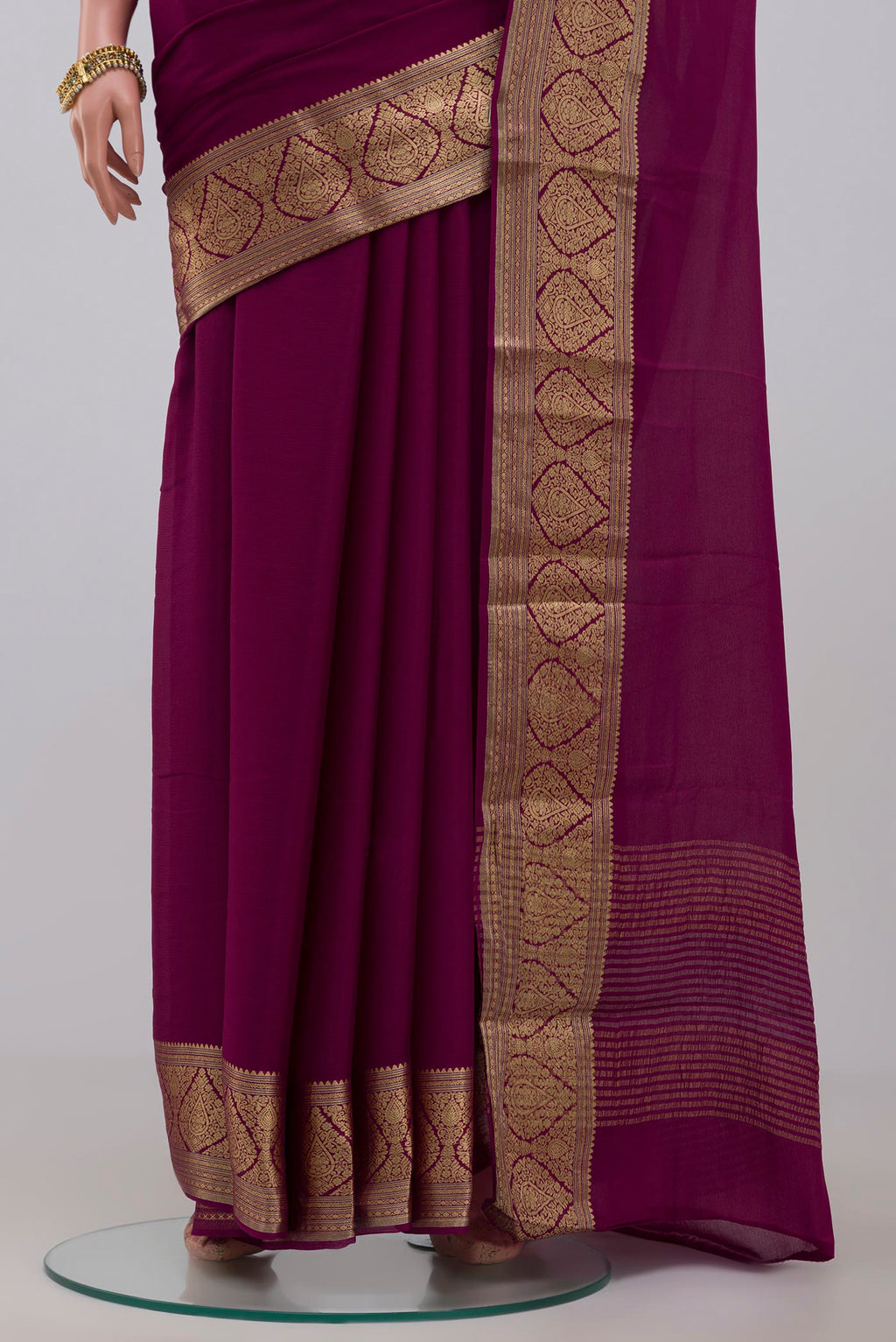 Pleats and pallu of Purple Chiffon Saree with Plain Body and Zari Border. 