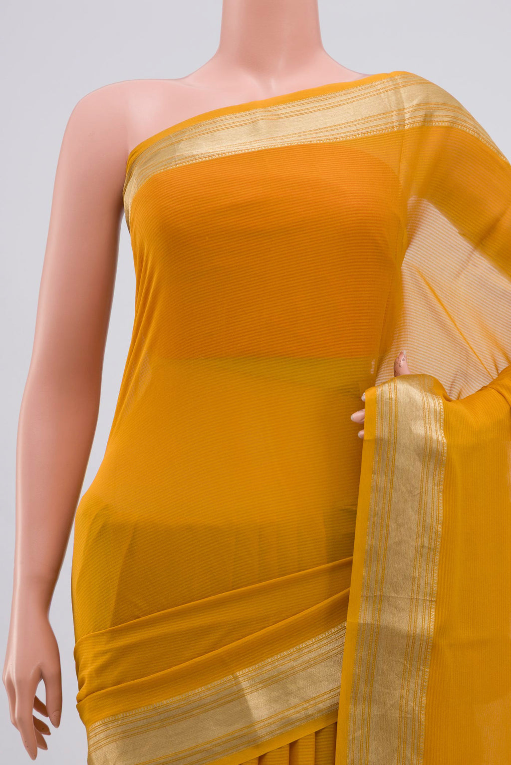 Border image of Mustard Georgette Saree with Zari Butta on the body and Zari Border. 