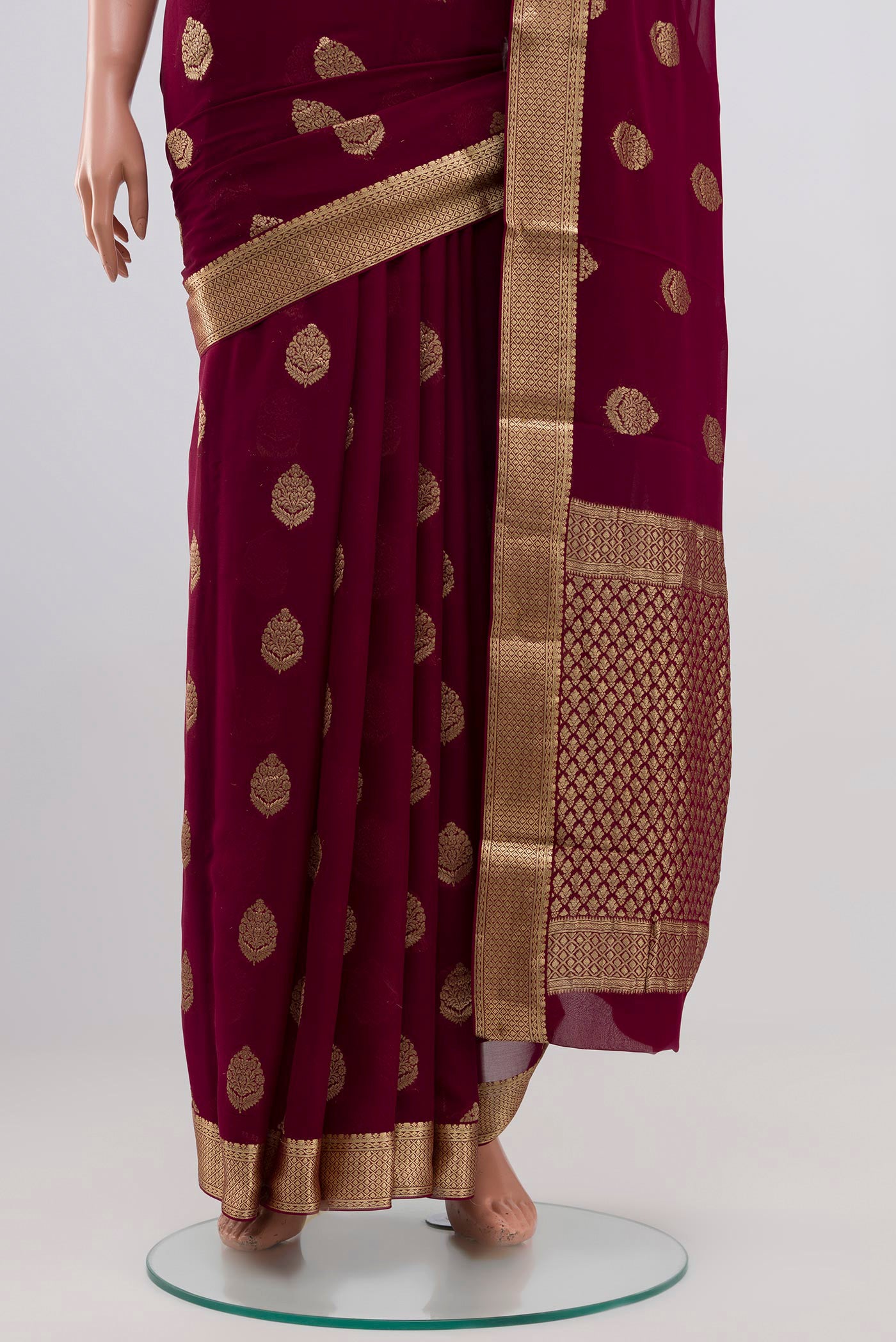 Pleats and pallu of Purple Georgette Saree with Zari Butta on the body and Zari Border. 