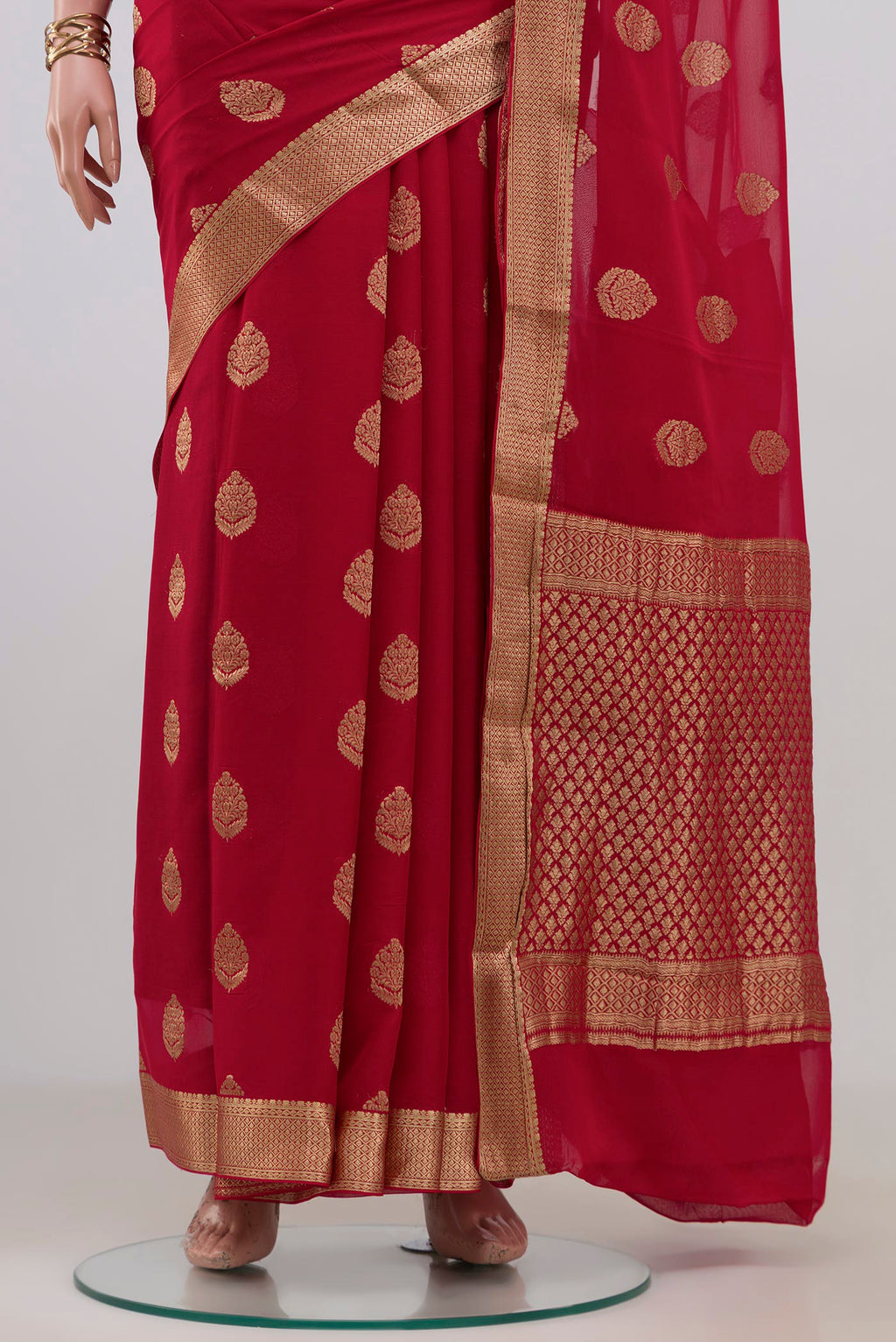 Pleats and pallu of Red Mysore Georgette Saree with Zari Butta on the body and Zari Border. 