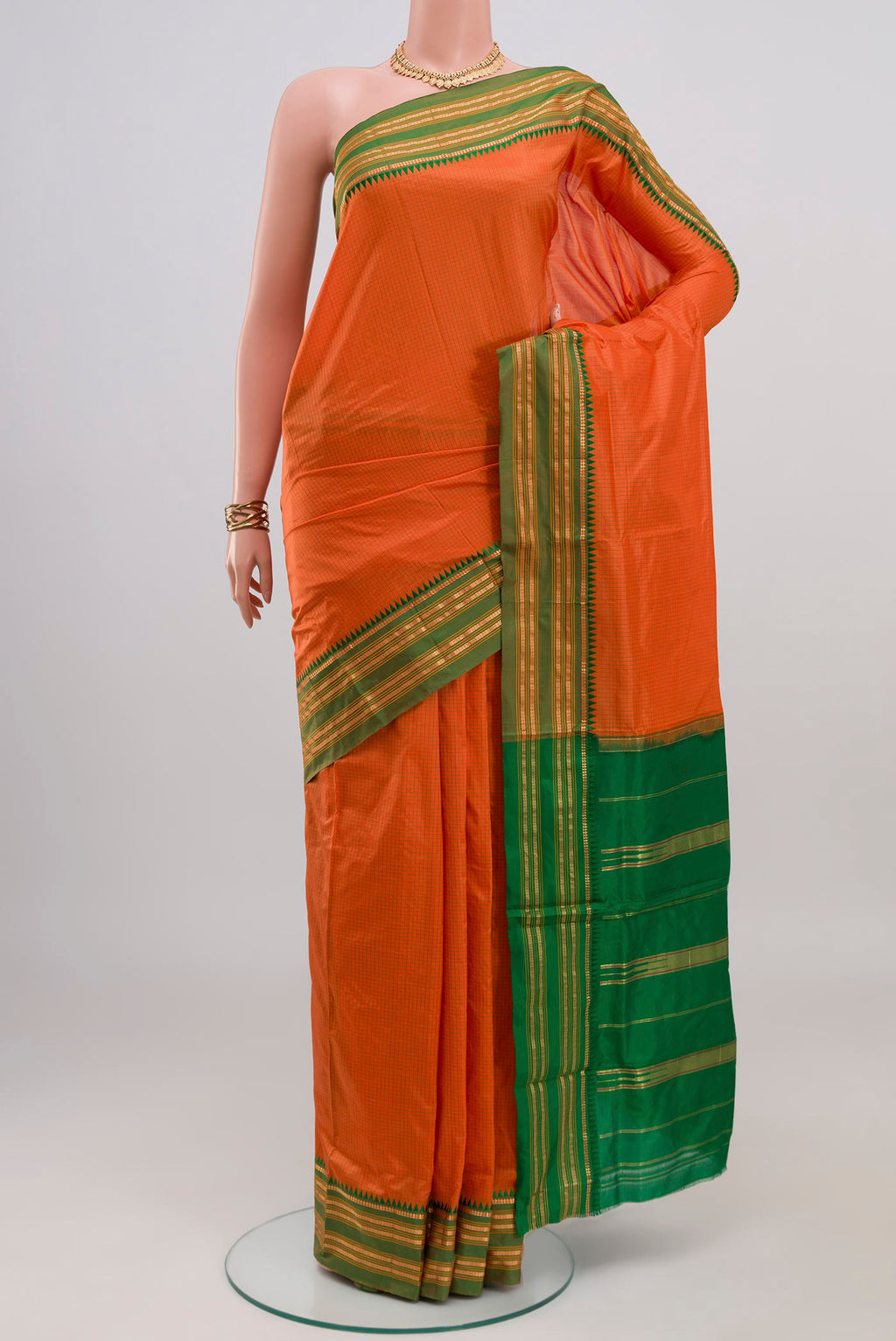 Orange Narayanpet Silk Saree with Checked design on the body and Zari Border.  displayed on a mannequin