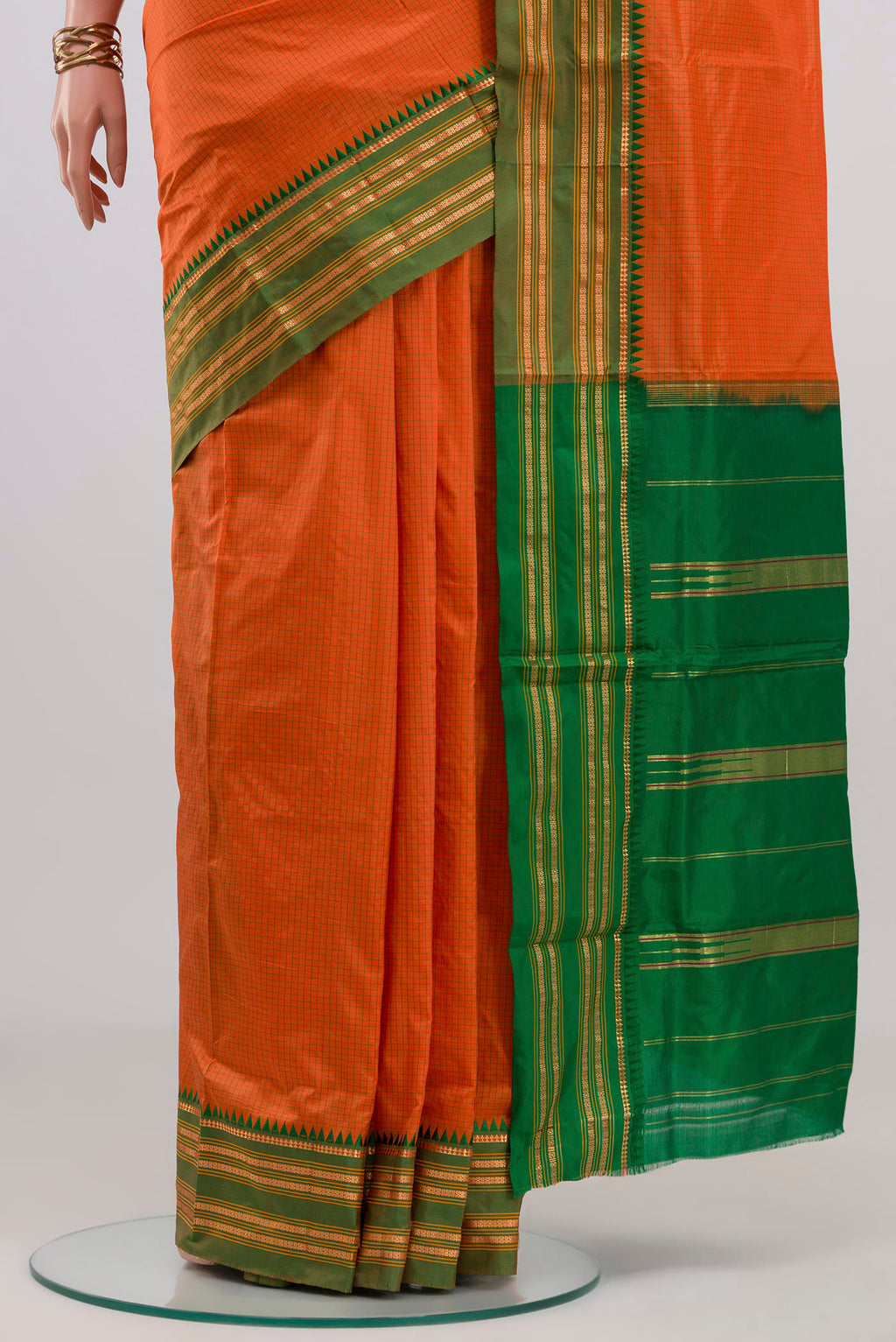 Pleats and pallu of Orange Narayanpet Silk Saree with Checked design on the body and Zari Border. 