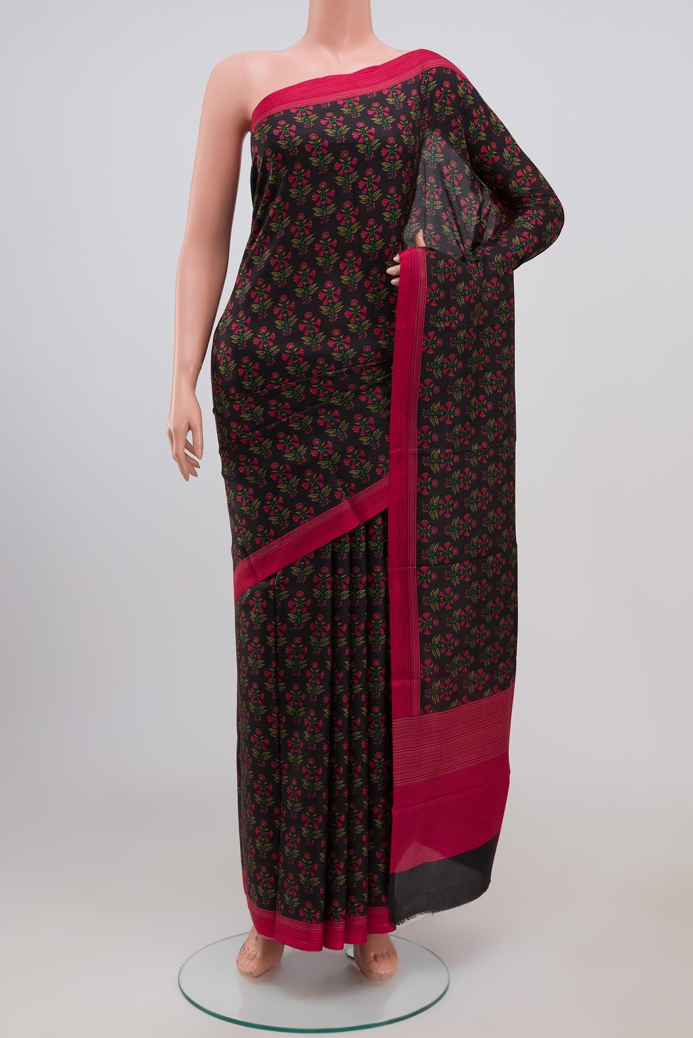 Black Crepe Saree with Printed design on the body and Plain Border.  displayed on a mannequin