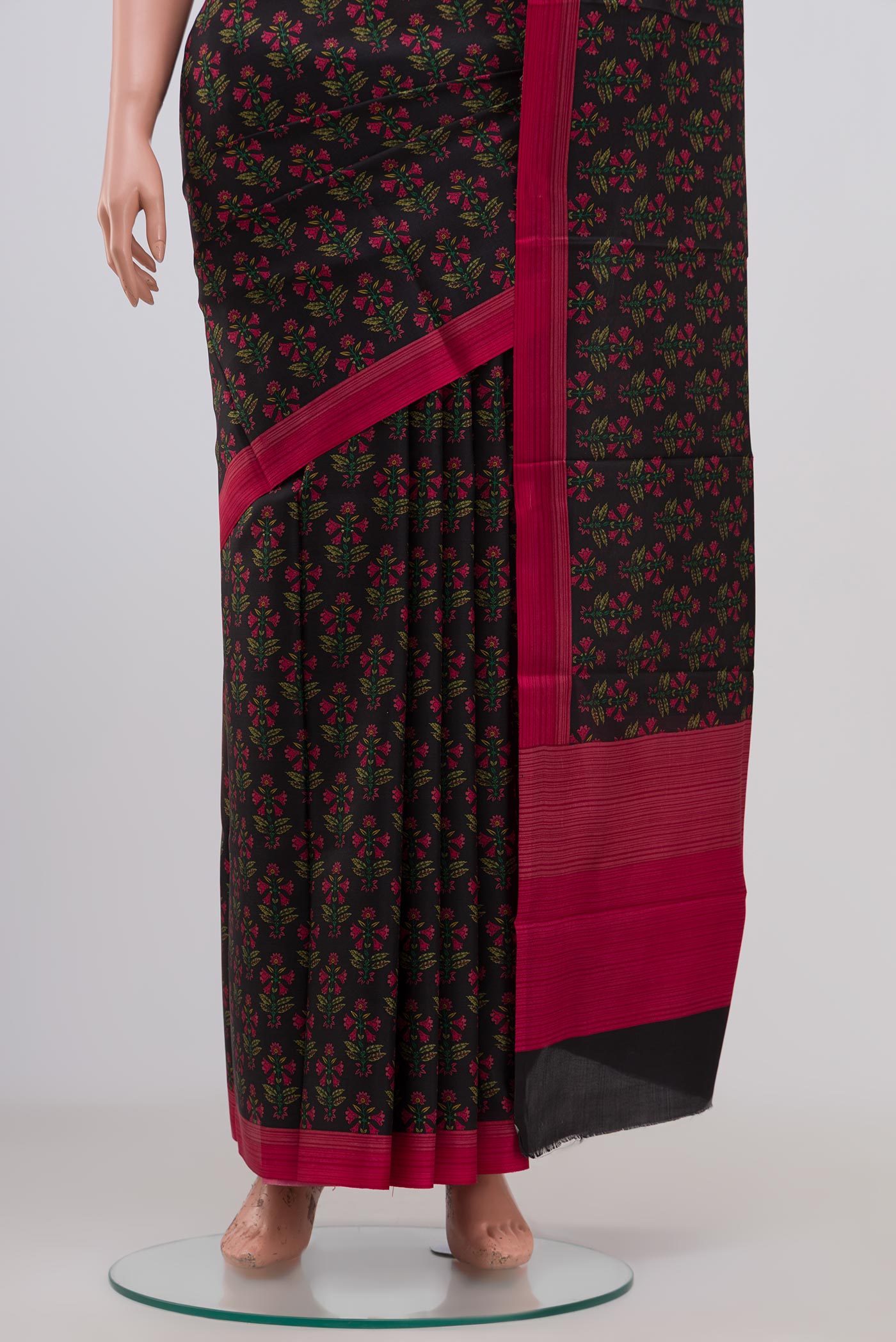 Pleats and pallu of Black Crepe Saree with Printed design on the body and Plain Border. 