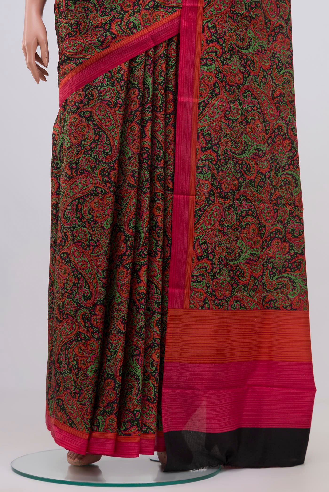 Pleats and pallu of Black Printed Silk Saree with Printed design on the body and Plain Border. 