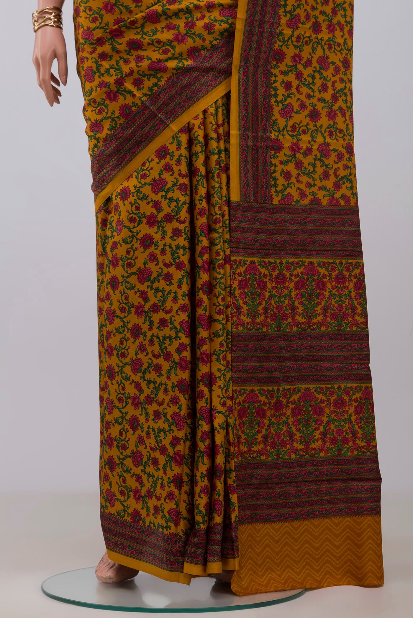 Pleats and pallu of Mustard Printed Silk Saree with Printed design on the body and Printed Border. 