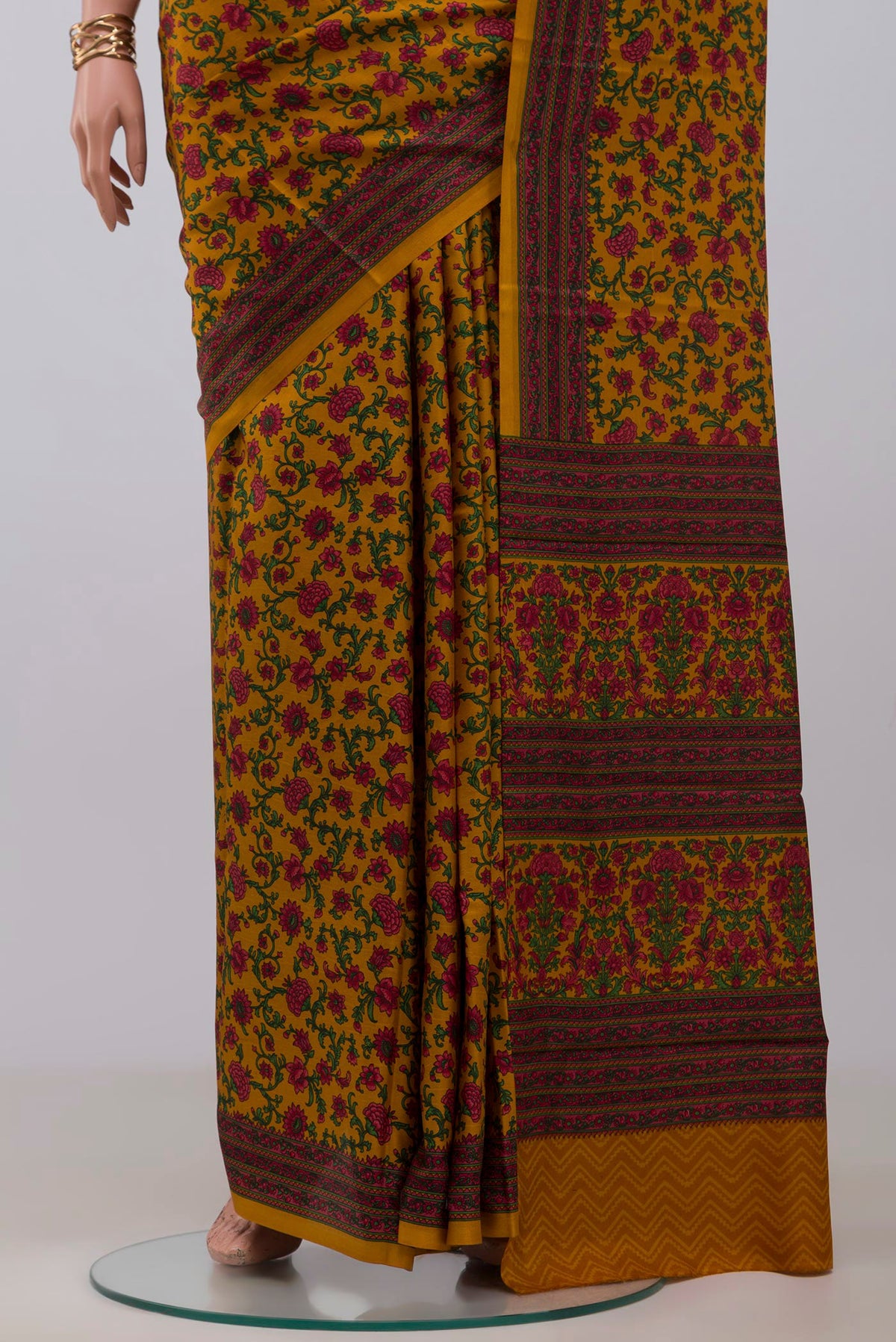 Pleats and pallu of Mustard Printed Silk Saree with Printed design on the body and Printed Border. 