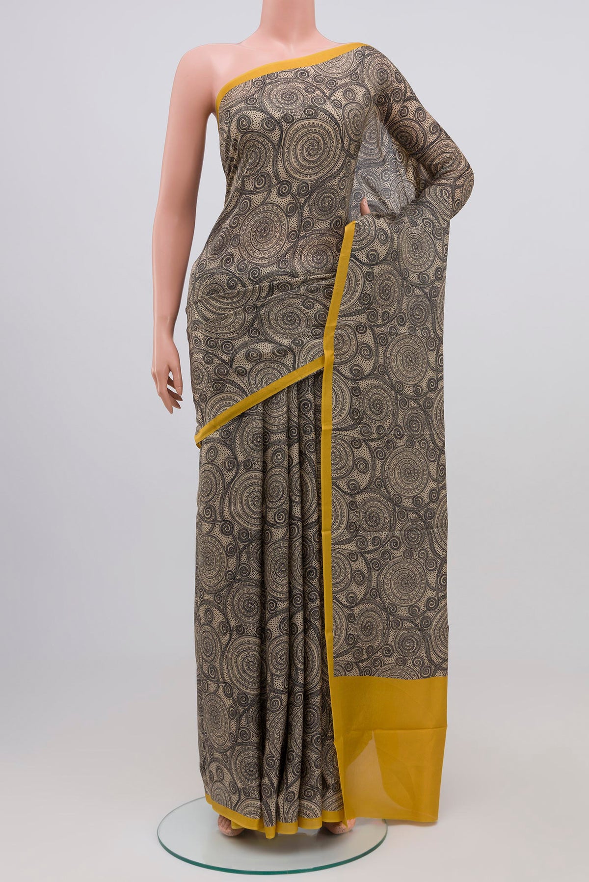 Beige Printed Silk Saree with Printed design on the body and Plain Border.  displayed on a mannequin